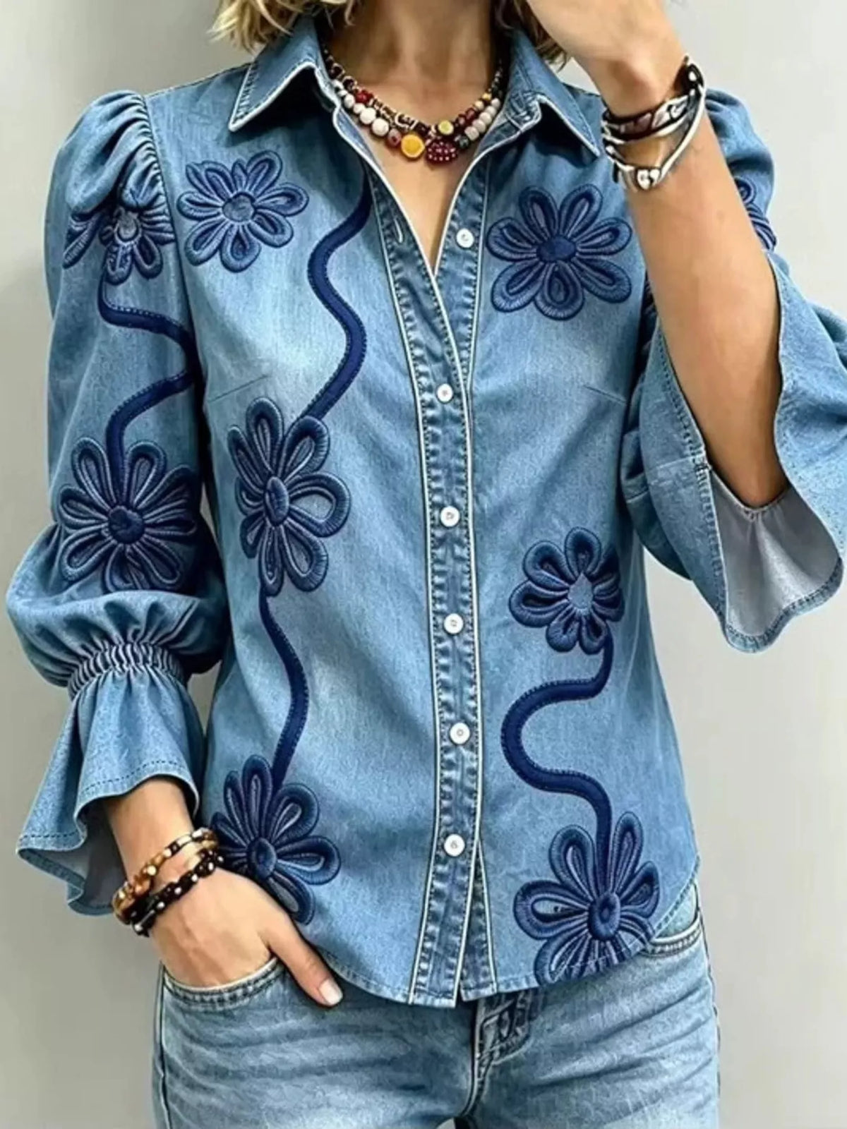 Blue floral-embroidered button-down shirt, front view.