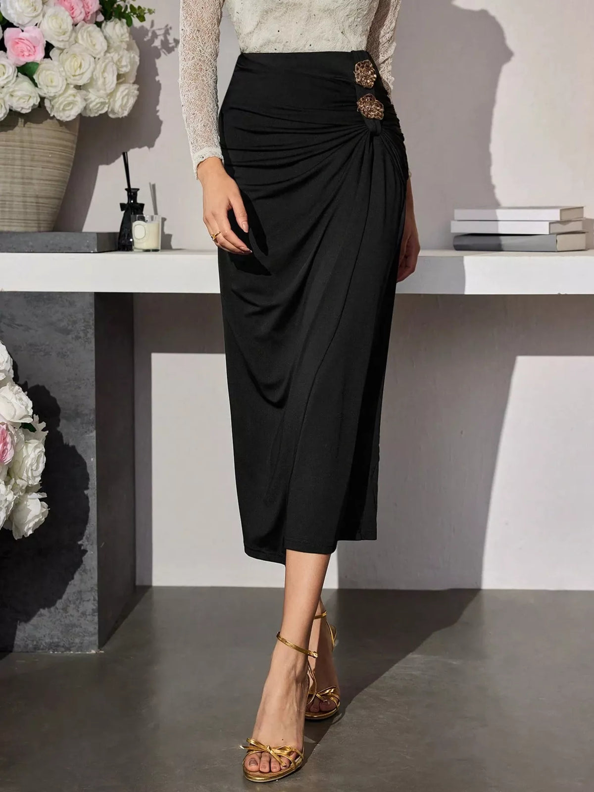 Black high-waisted ruched button-detail midi skirt, full front view.
