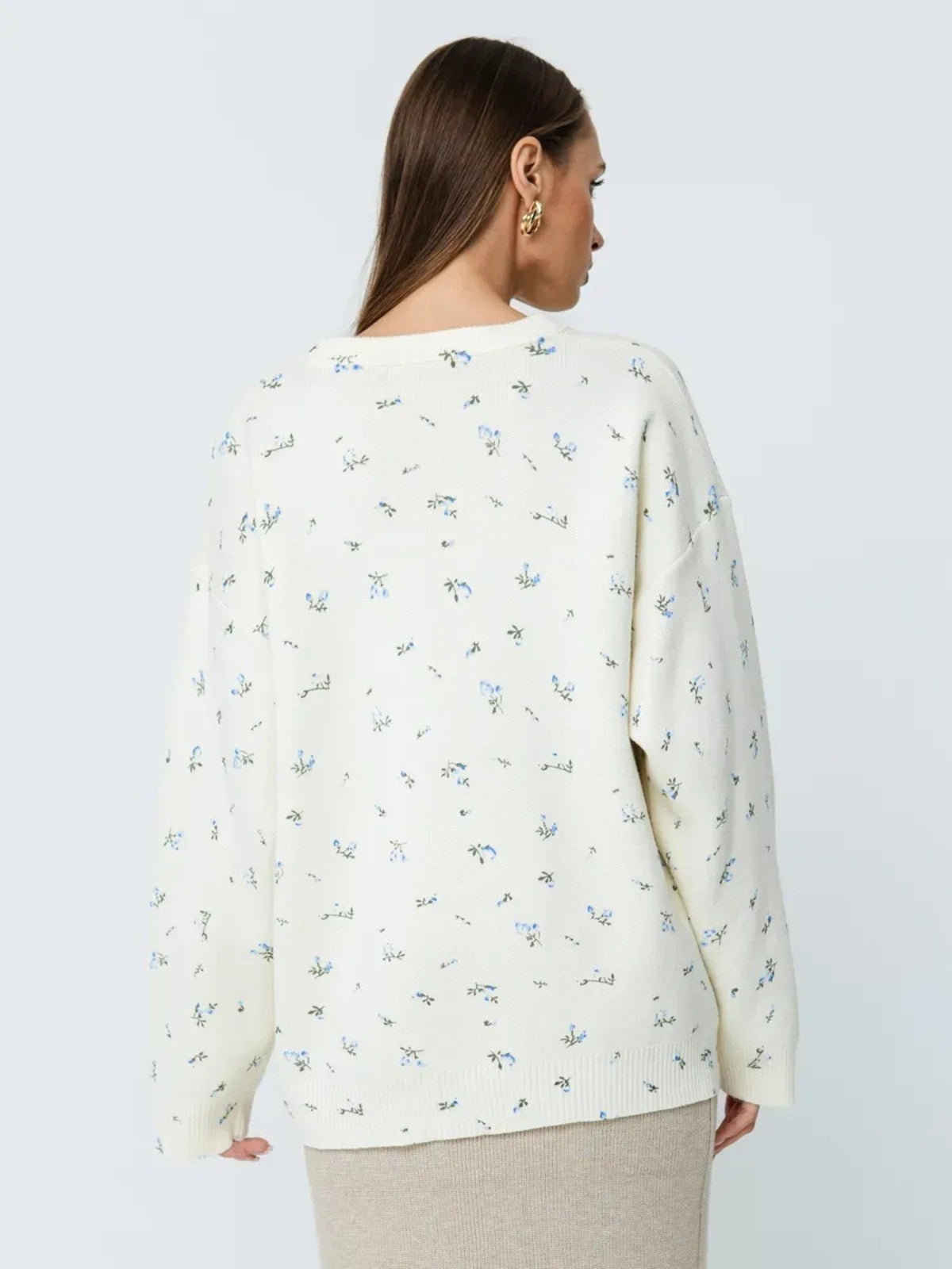 White floral dropped-shoulder oversized sweater, back view.