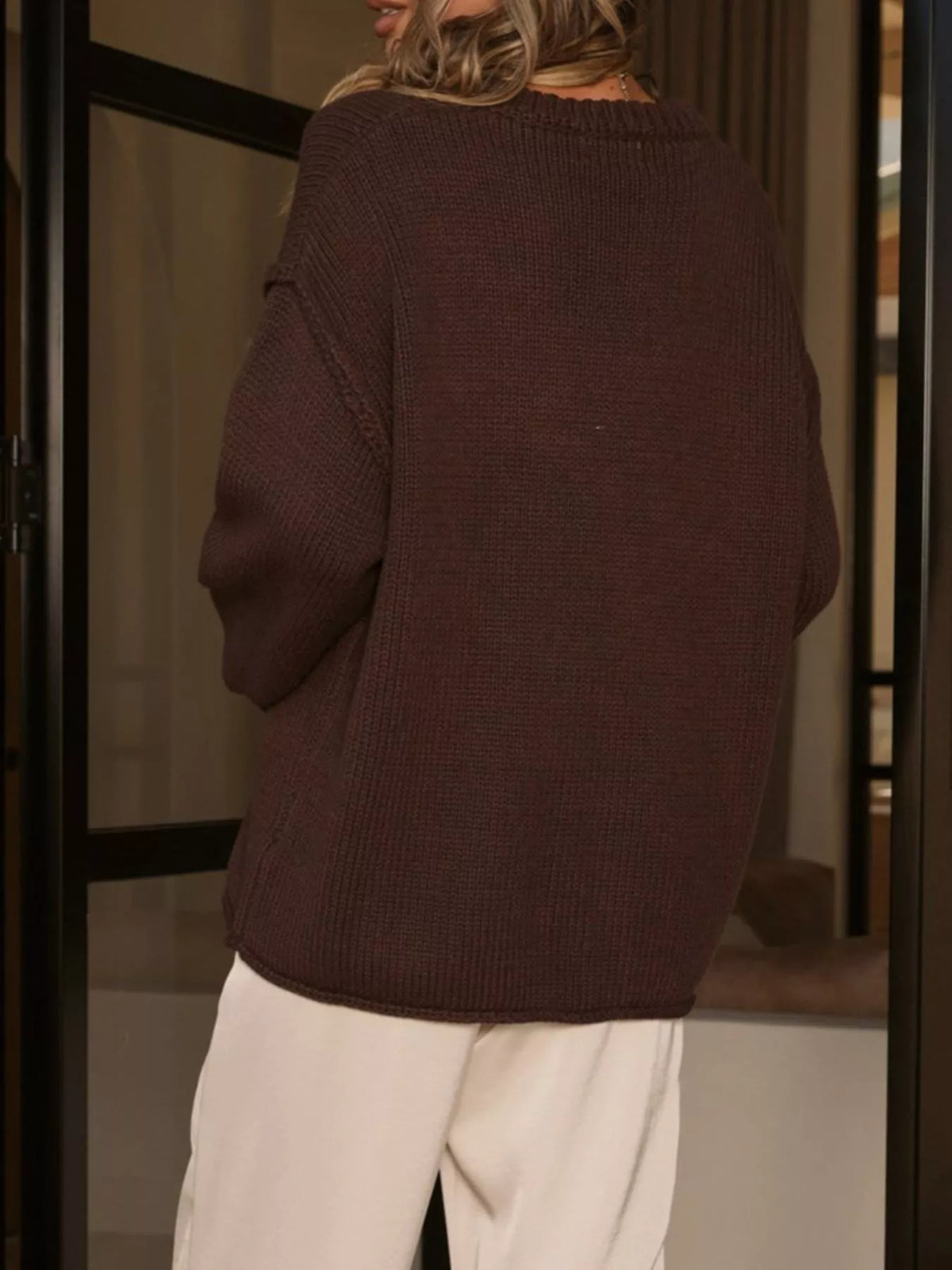 Brown crewneck dropped-shoulder sweater, back view.