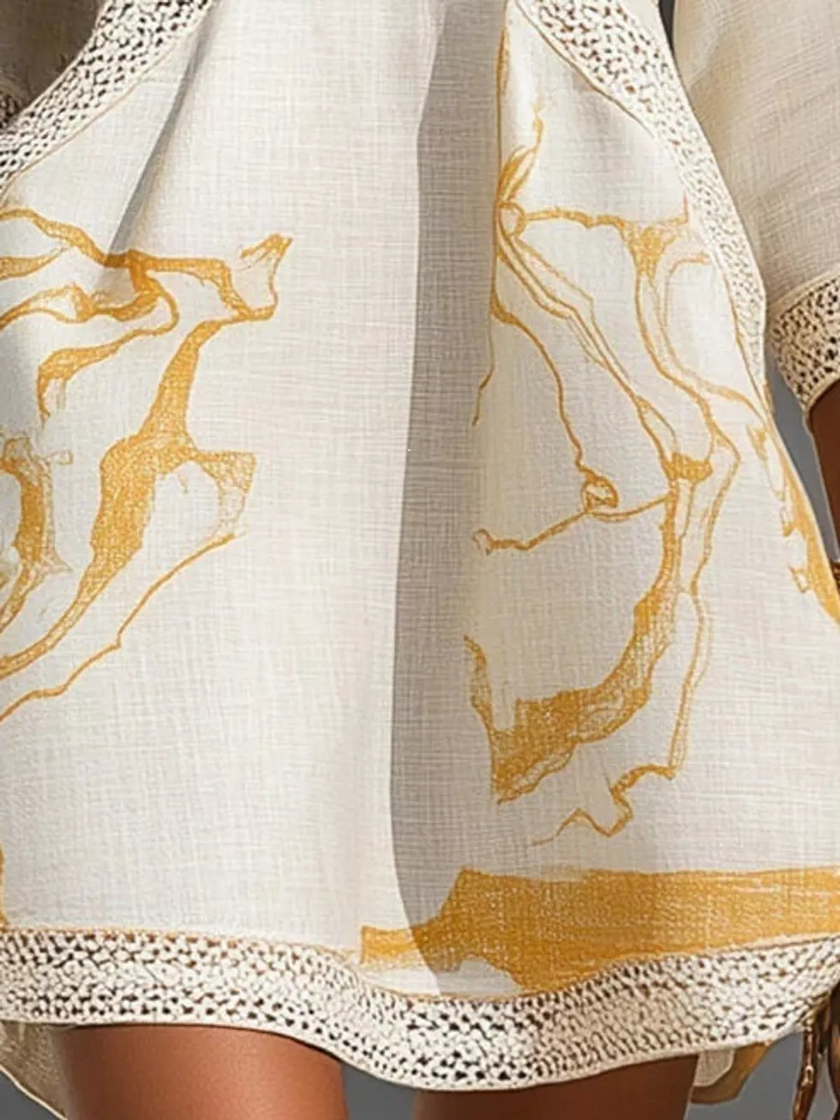 White notched 3/4 sleeve mini dress, close-up of the print and hem trim