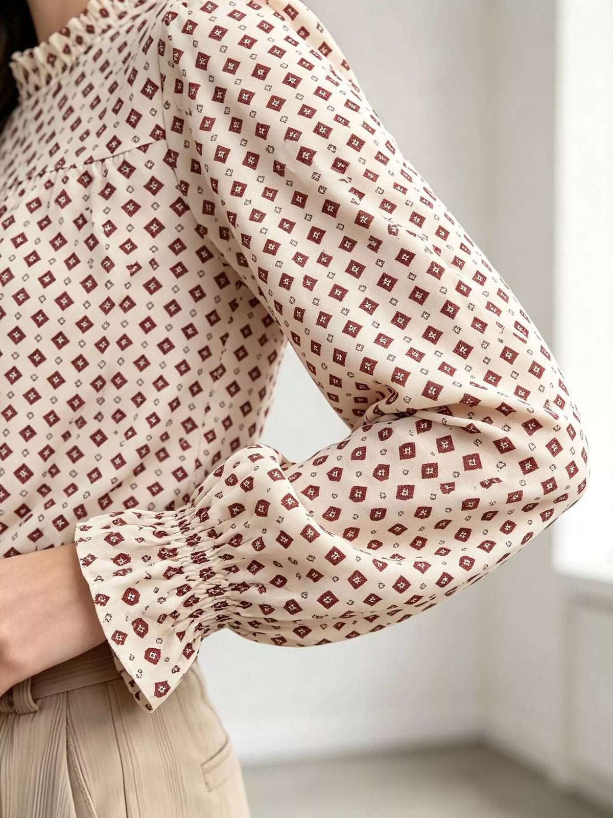 Geometric-print blouse, cream sleeve detail