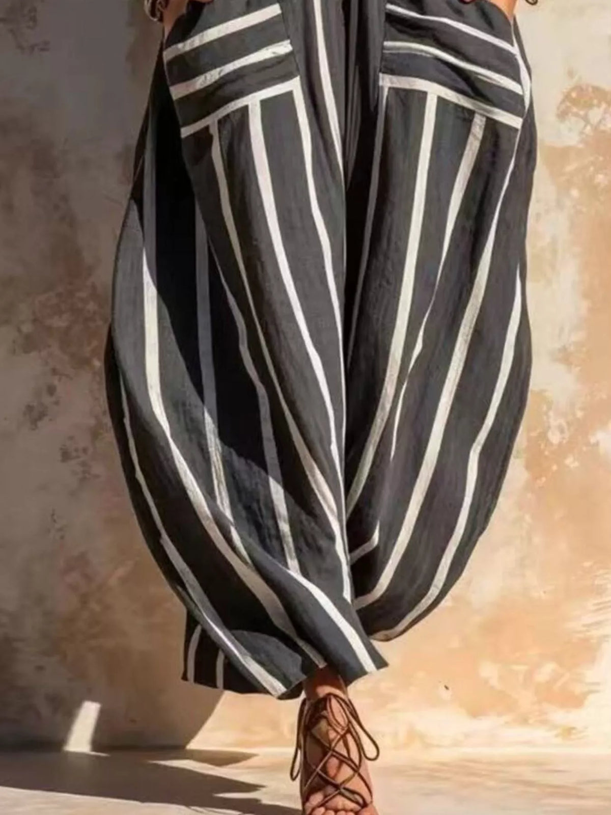 Black and white striped sleeveless jumpsuit, pocket and leg detail