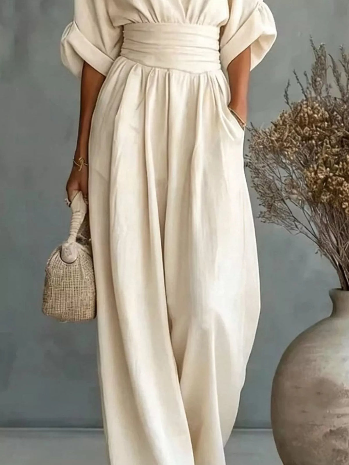 Cream V-neck wide-leg jumpsuit, front and leg detail