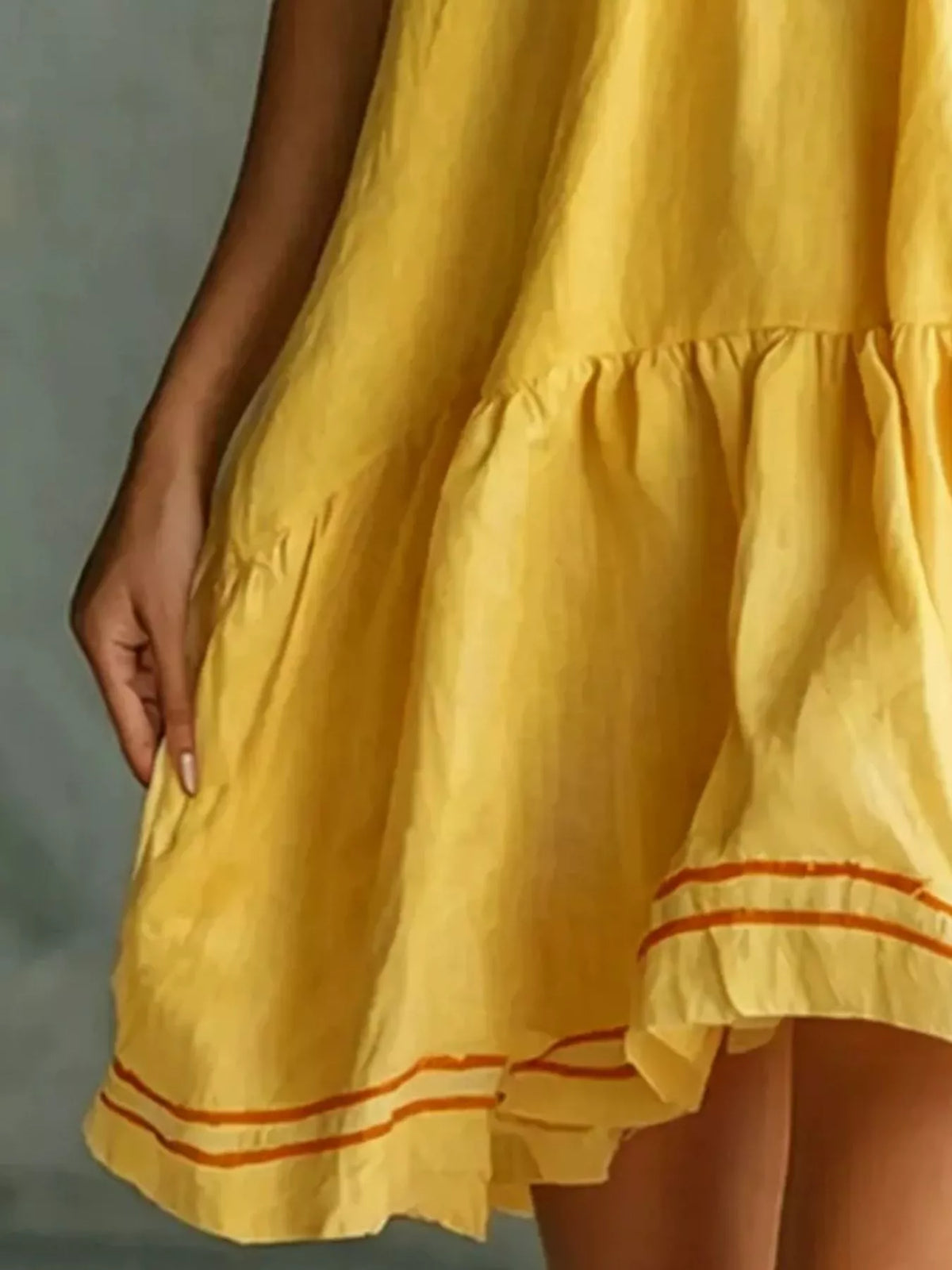 Sleeveless Tiered Mini Dress in yellow, hem detail