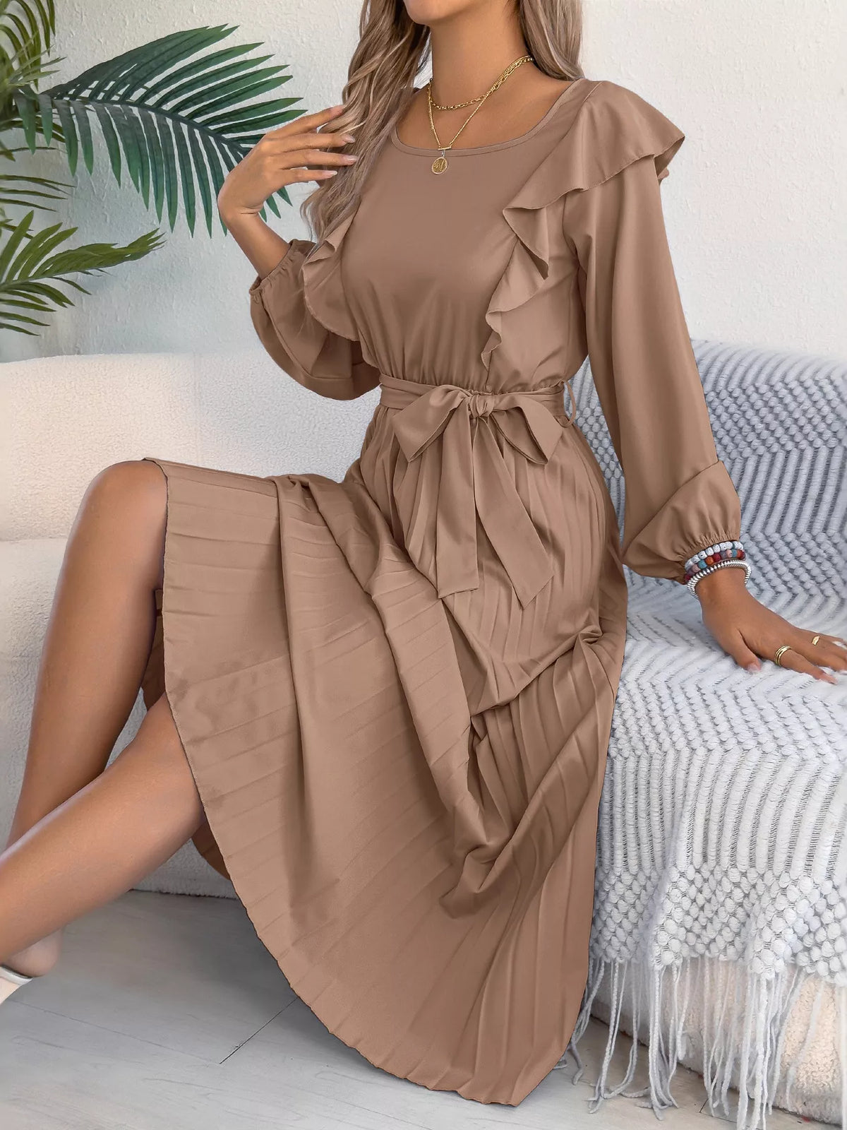 Taupe ruffled pleated tie-waist midi dress, seated bodice detail.