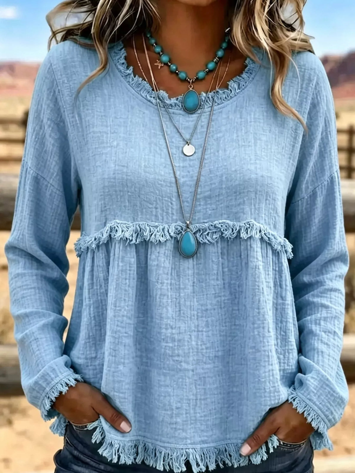 Light blue frayed hem textured blouse, front view