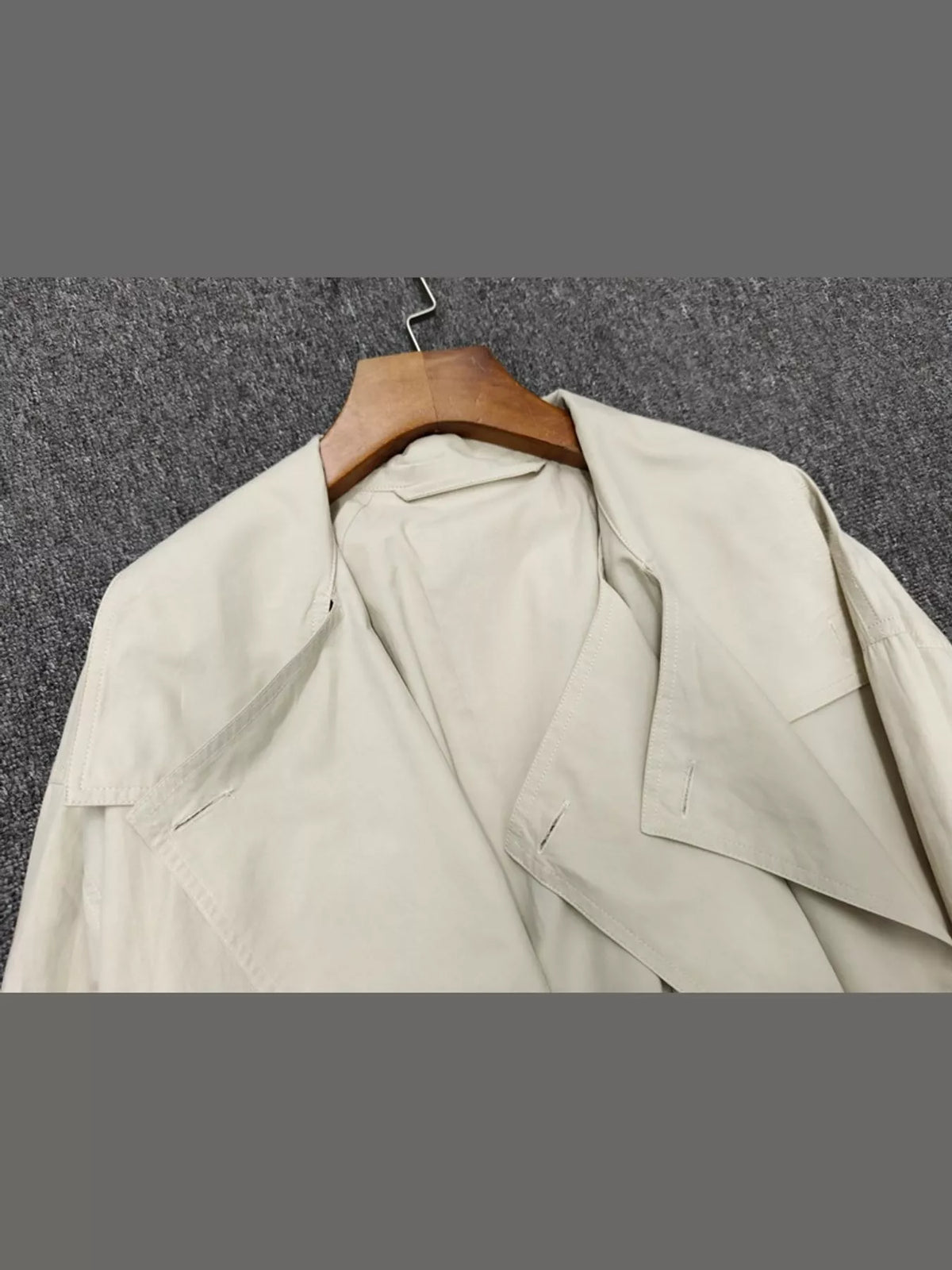 Cream double-breasted utility jacket with drawstring hem — design and construction details