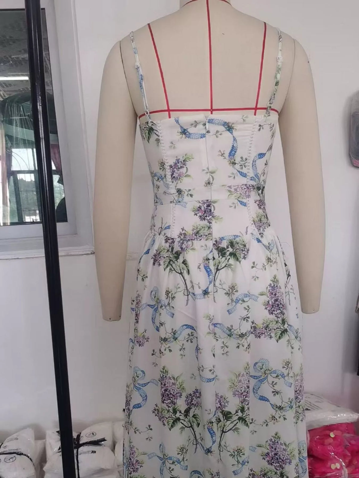 Women's Paneled Bodice Gathered Midi Dress in blue floral — mannequin back view