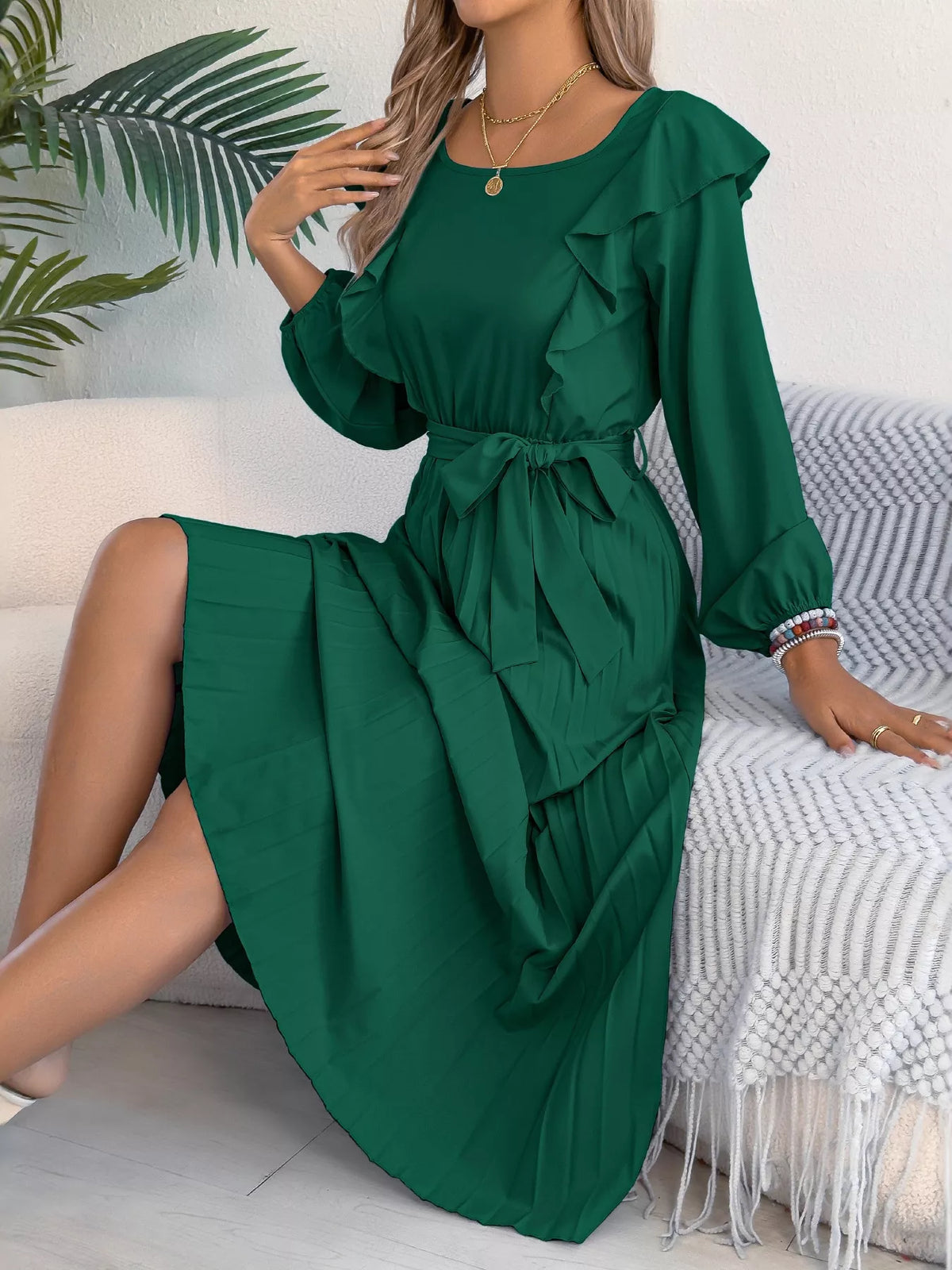 Green ruffled pleated tie-waist midi dress, seated front view.