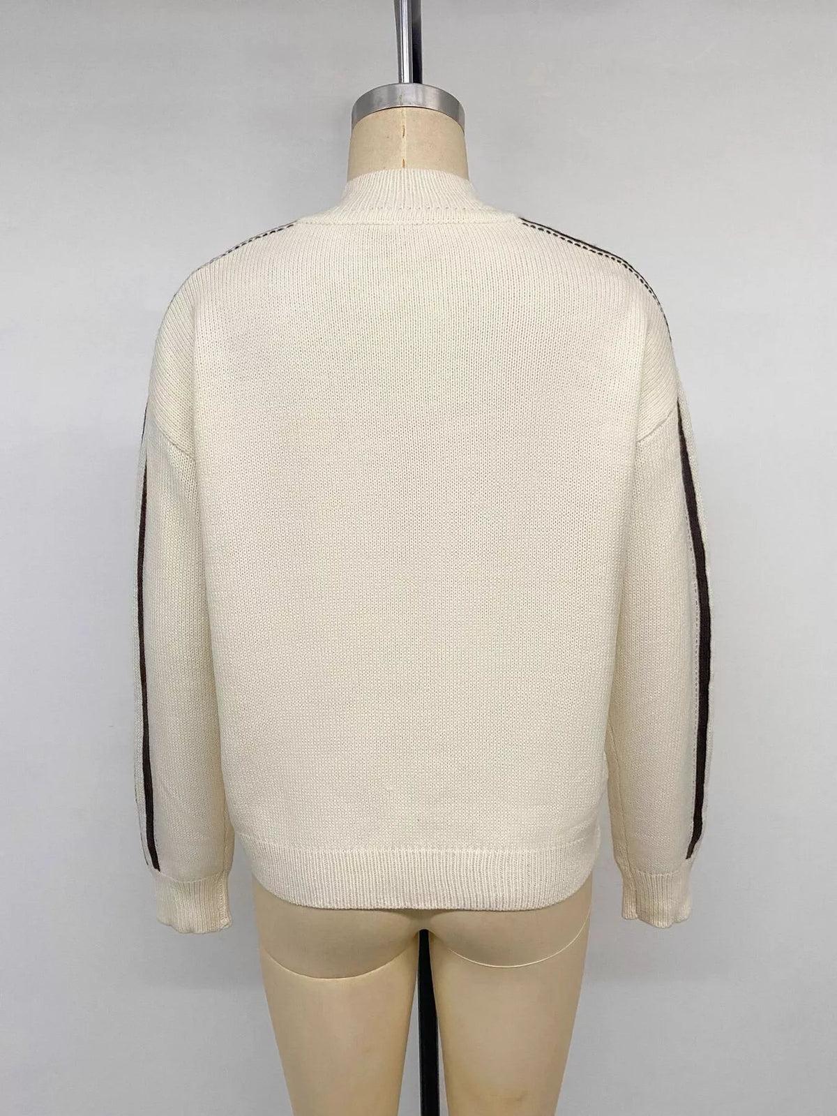 Cream Chinese knot button cardigan with sleeve stripes, back on mannequin