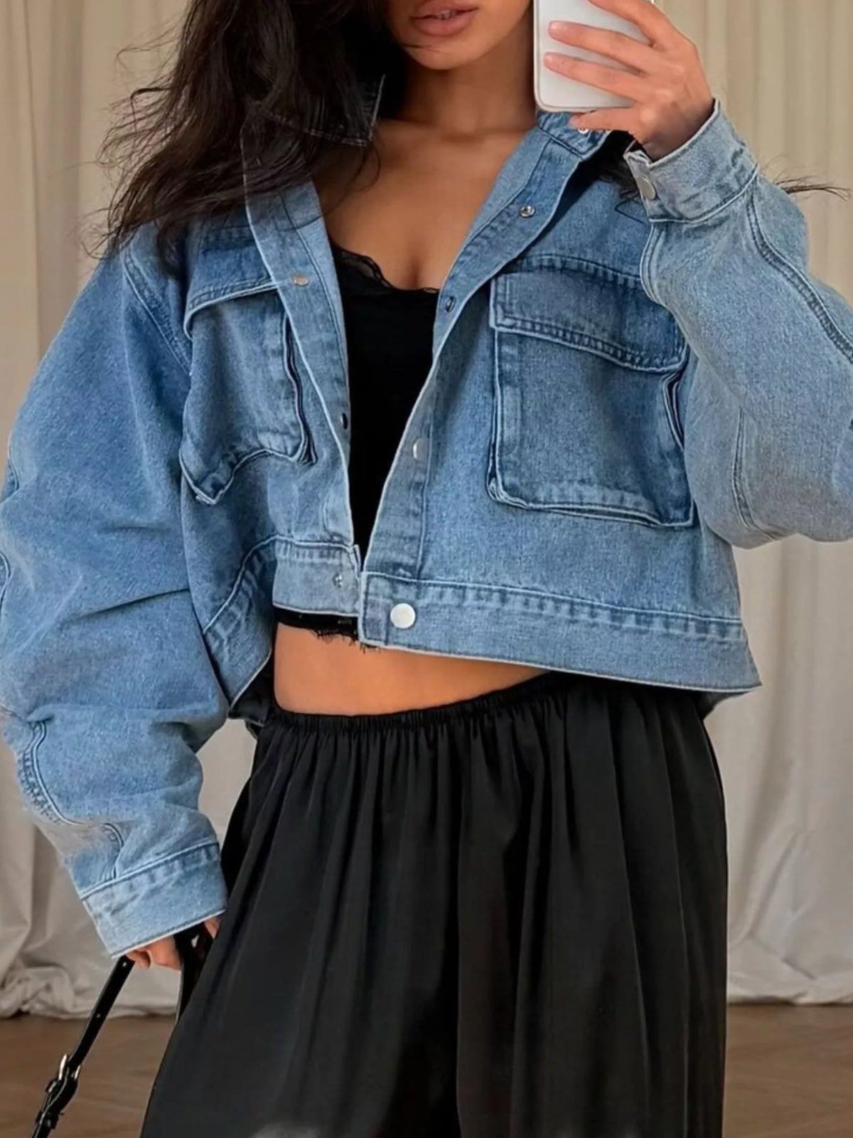 Blue oversized cropped denim utility jacket, front view showing cropped hem.