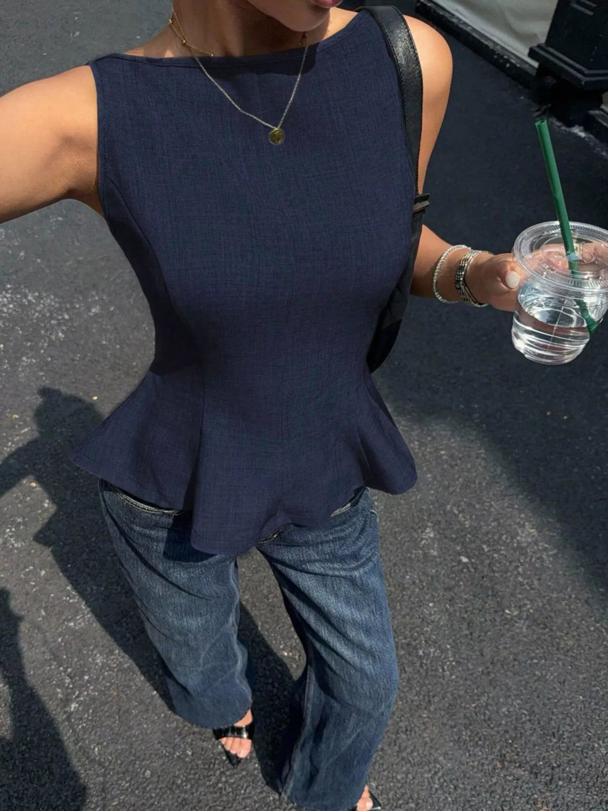 Navy open-back bow-tie peplum tank top, front viewed from above.