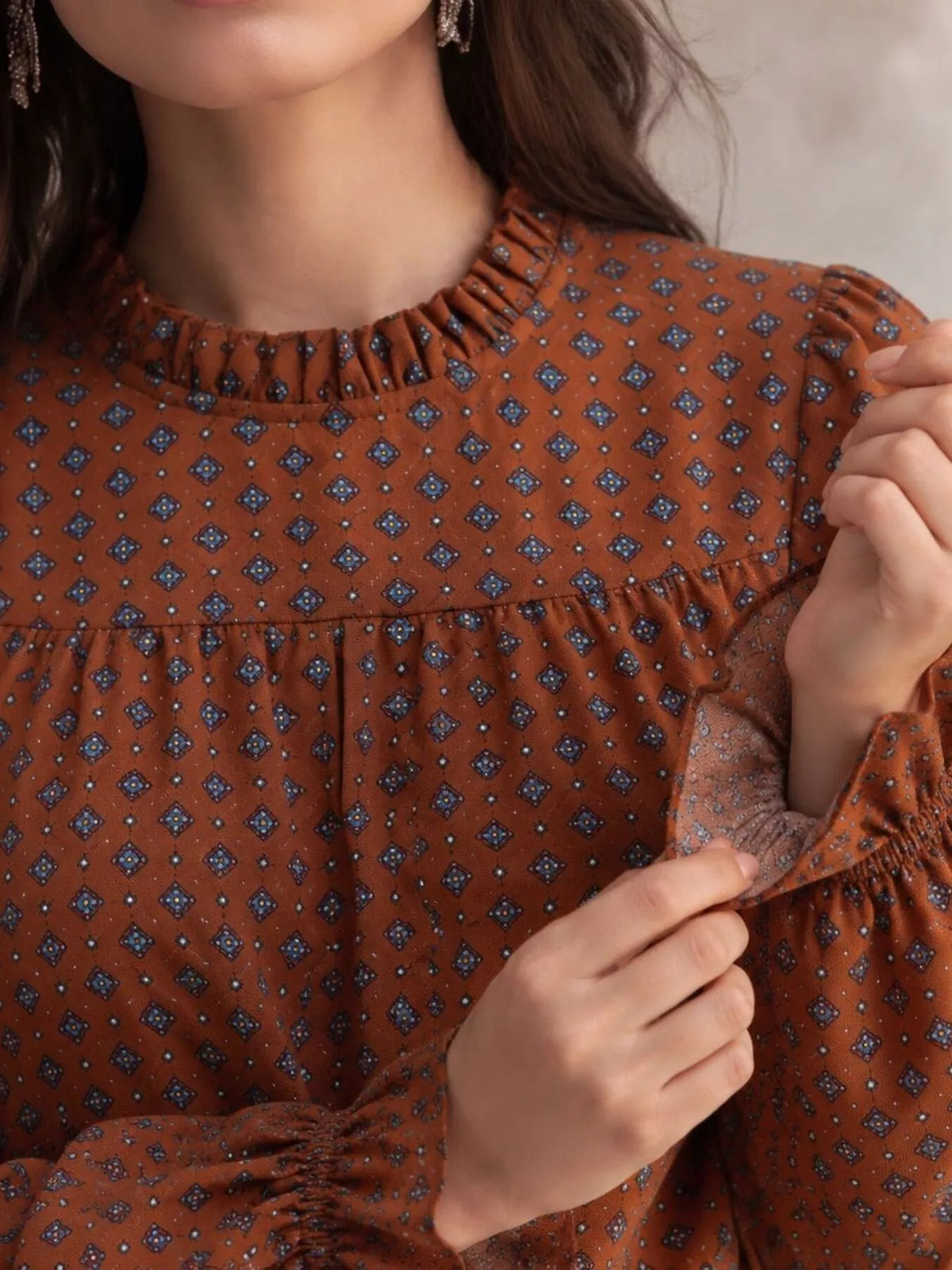 Geometric-print blouse, brown neckline detail
