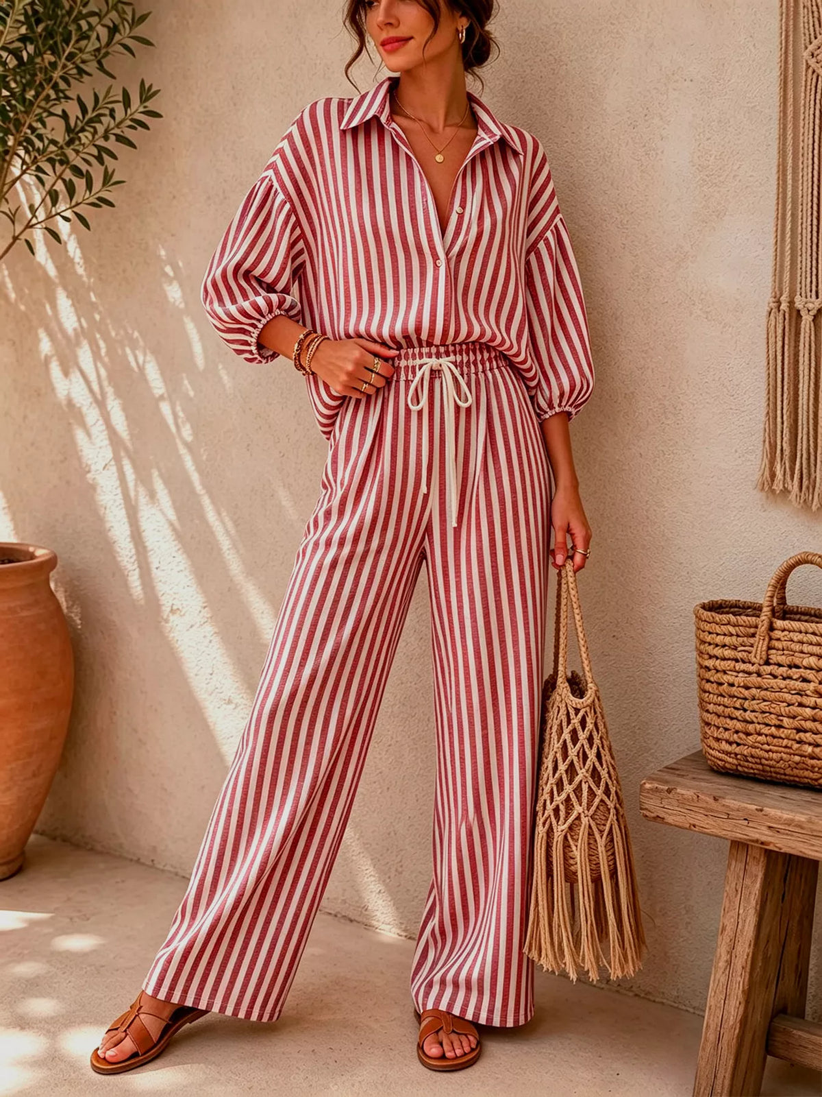 Red and white striped shirt and drawstring pants set, front view with hand at waist