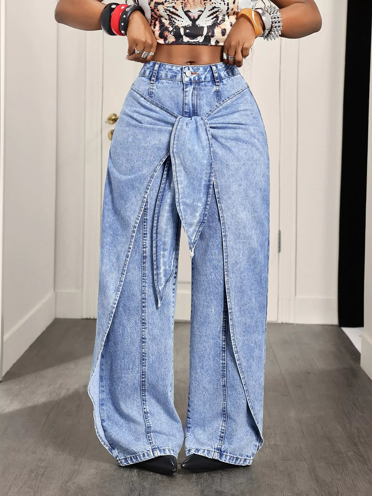 Light blue ruffled wide-leg jeans, front view with hands at waist
