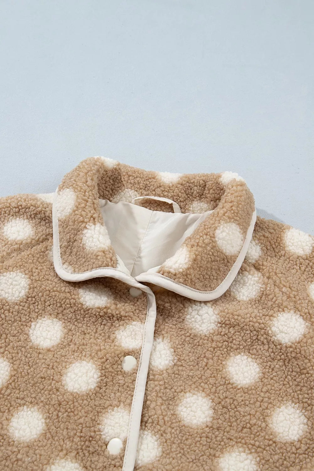 Tan and white polka dot faux fur button-front jacket with zip pockets, collar detail