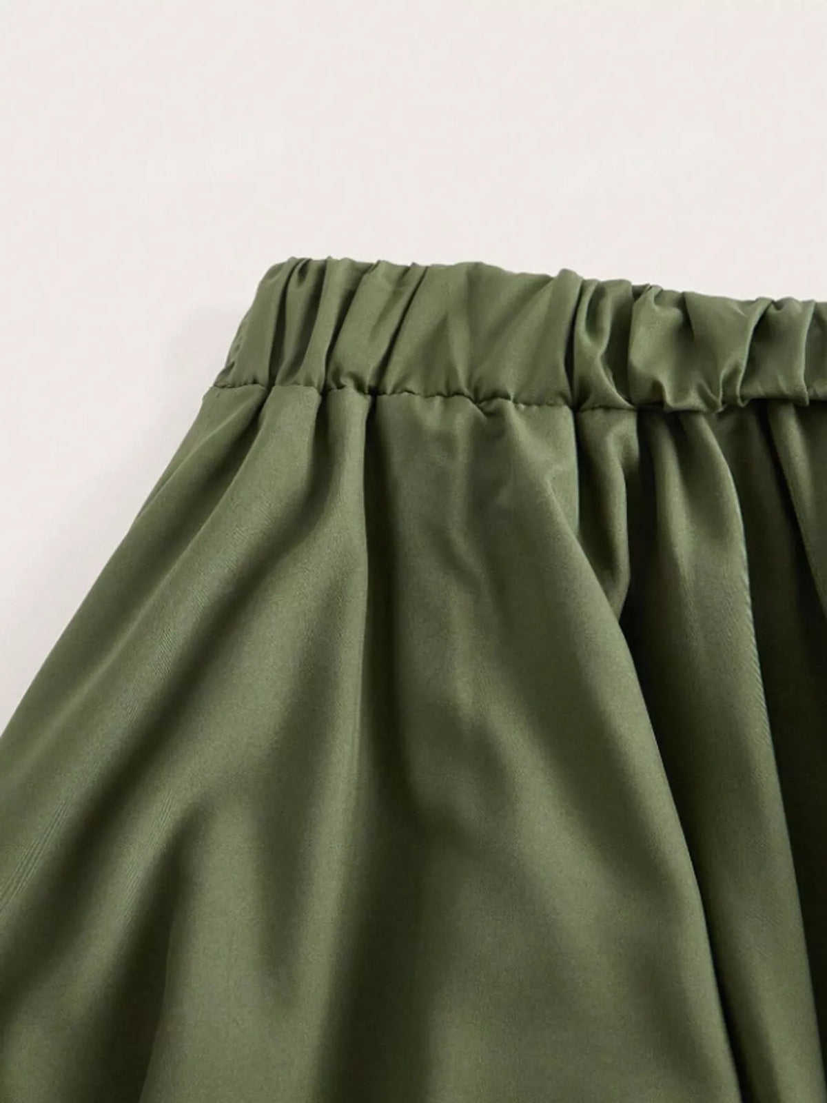 Asymmetric lace skirt, olive waistband detail