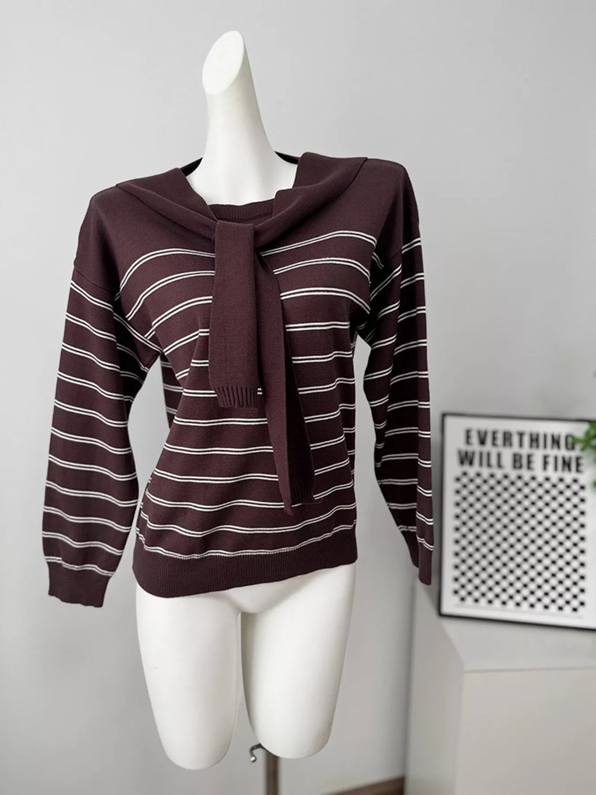 Striped crewneck sweater with layered tie detail in brown, front mannequin view with tie