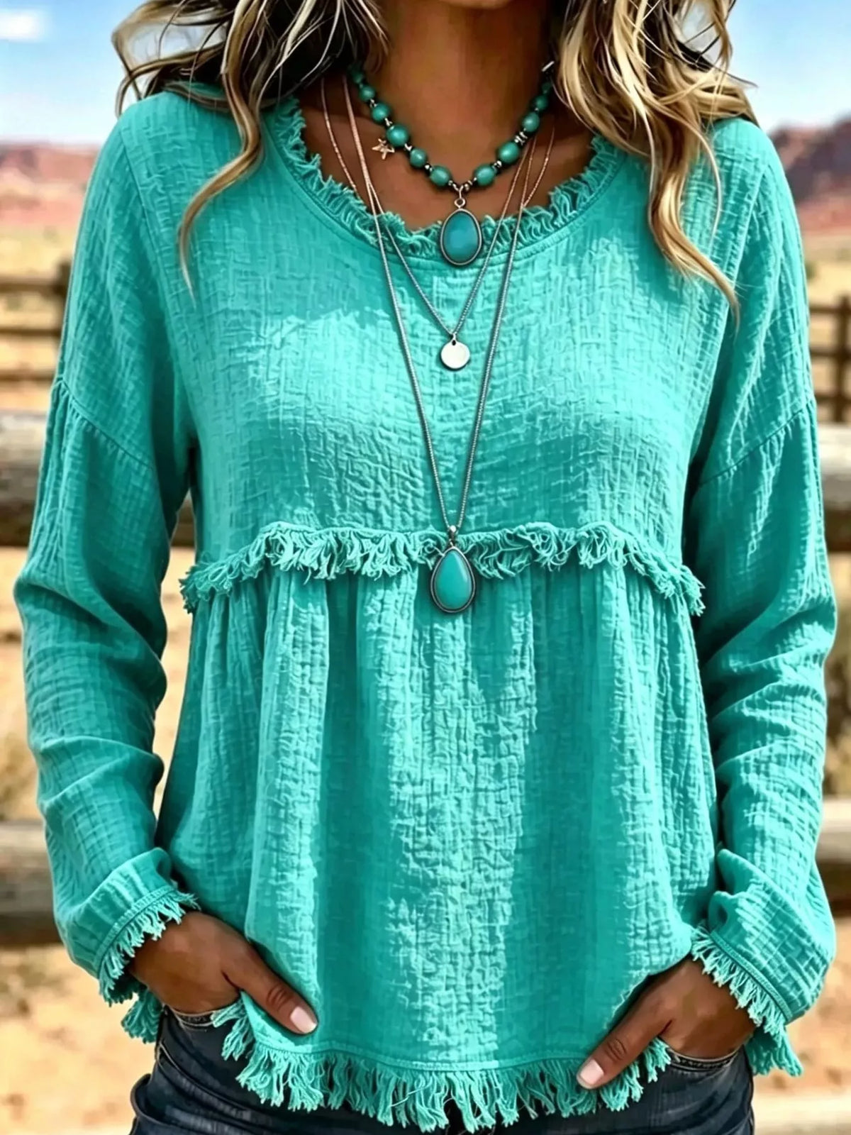 Teal frayed hem textured blouse, front view