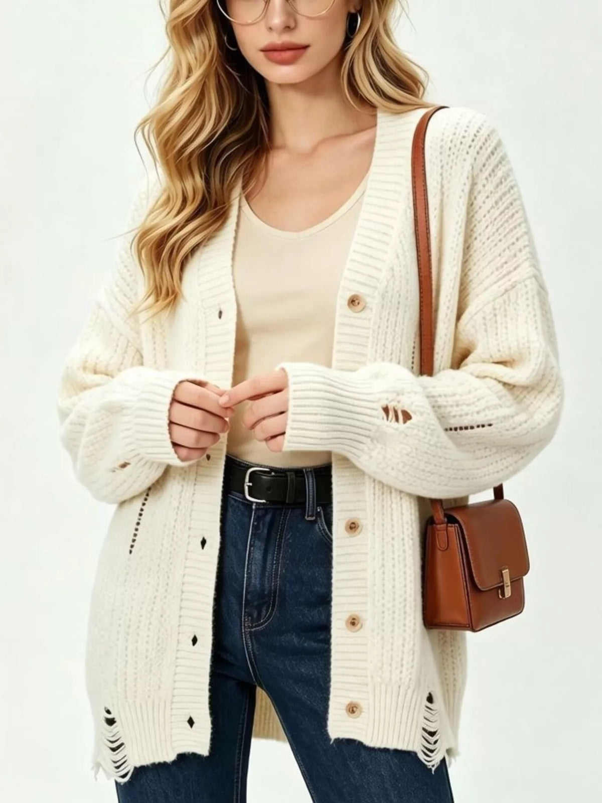 Beige distressed cardigan, cuff and hem view
