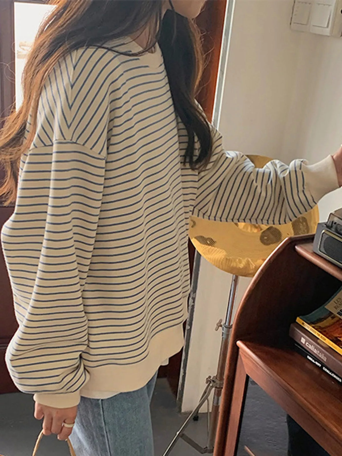 Cream and blue striped long sleeve crewneck t shirt, side view