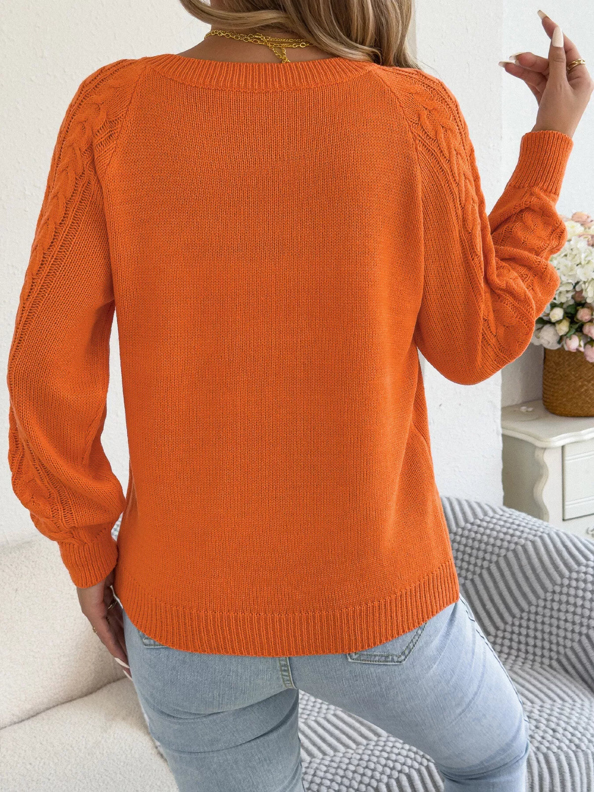 Orange cable knit button-front cardigan, back view