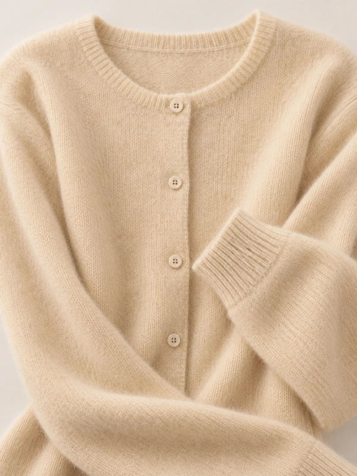 Women's Crew Neck Button-Down Knit Cardigan in cream — neckline detail view