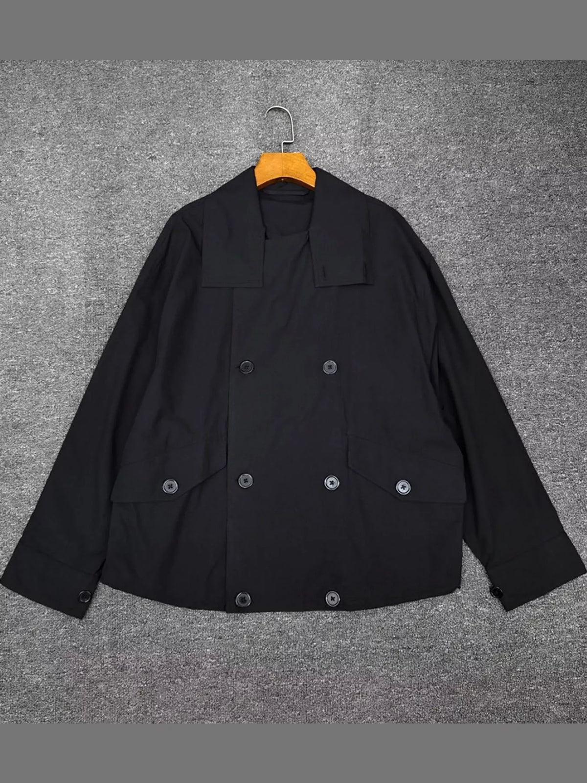 Black double-breasted utility jacket with drawstring hem — front view