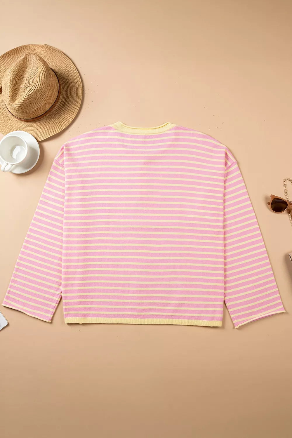 Pink and yellow striped button-detail sweater, back laid flat