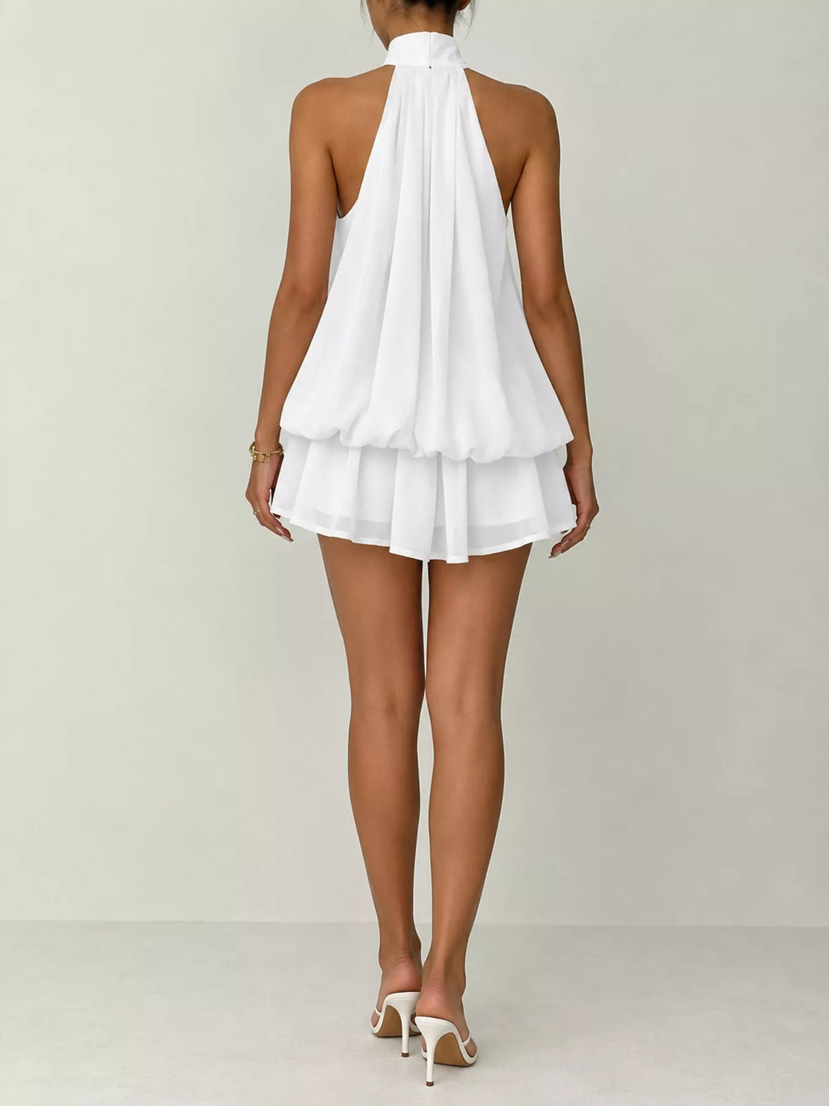 White halter neck layered mini dress, back view