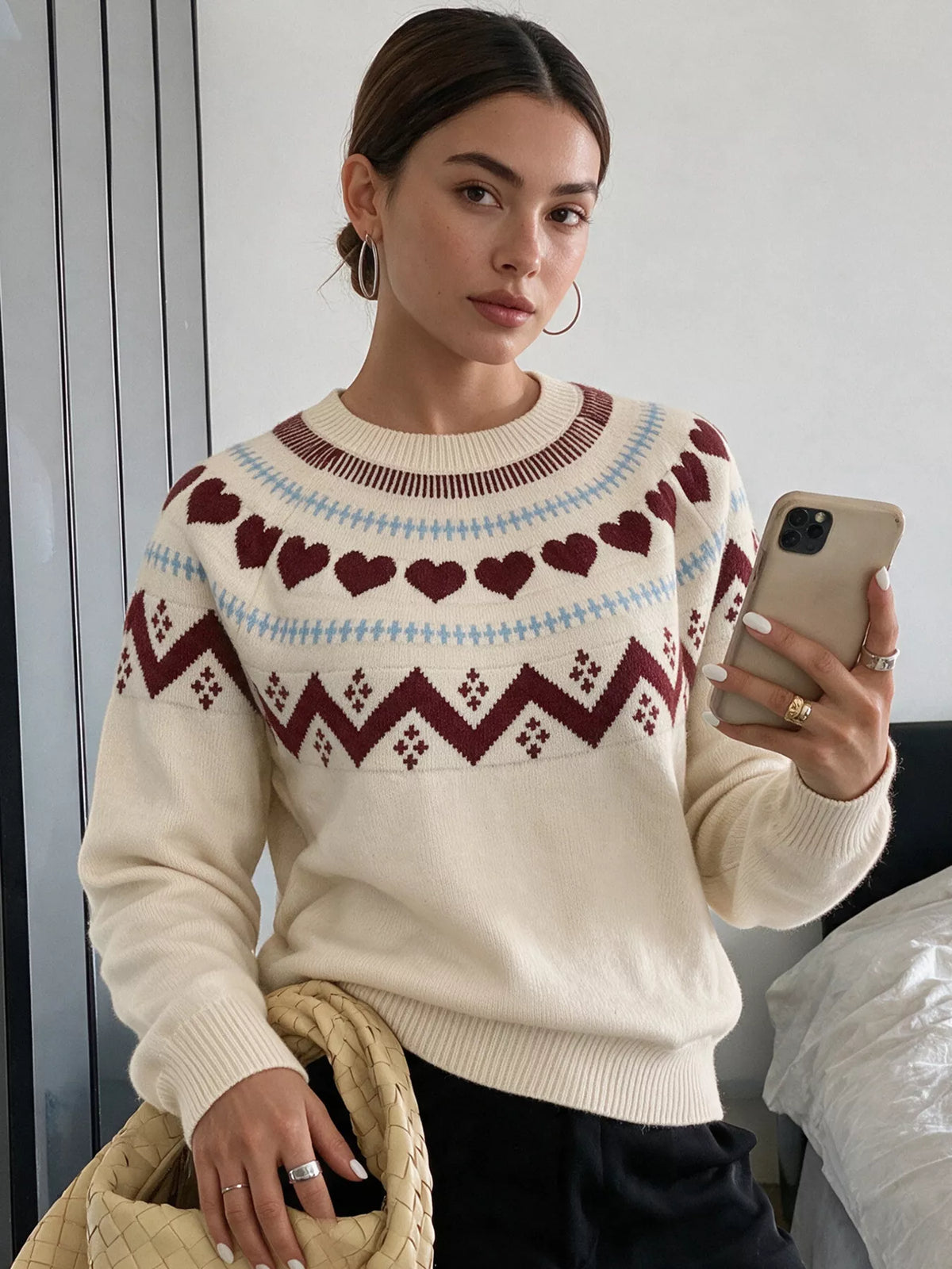 Cream heart-patterned crew neck sweater, front seated view