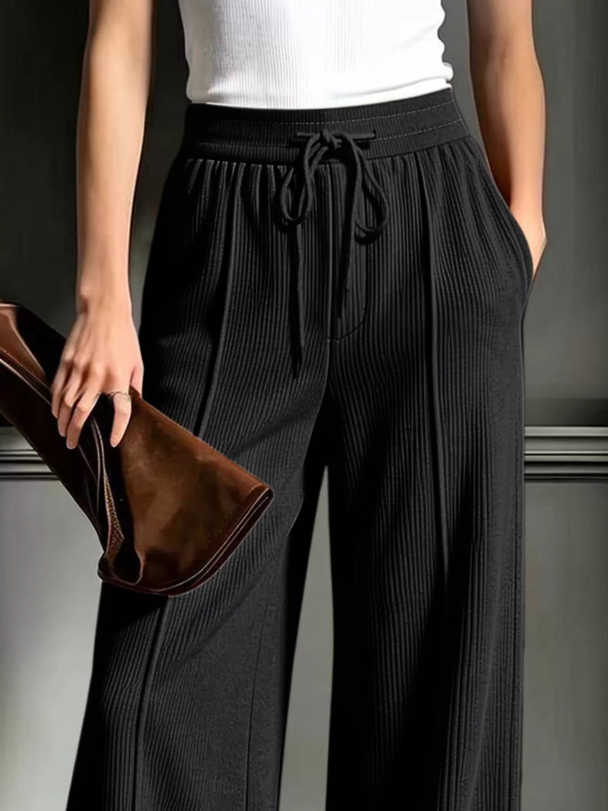 Black wide-leg ribbed corduroy pants, drawstring waistband and side pockets