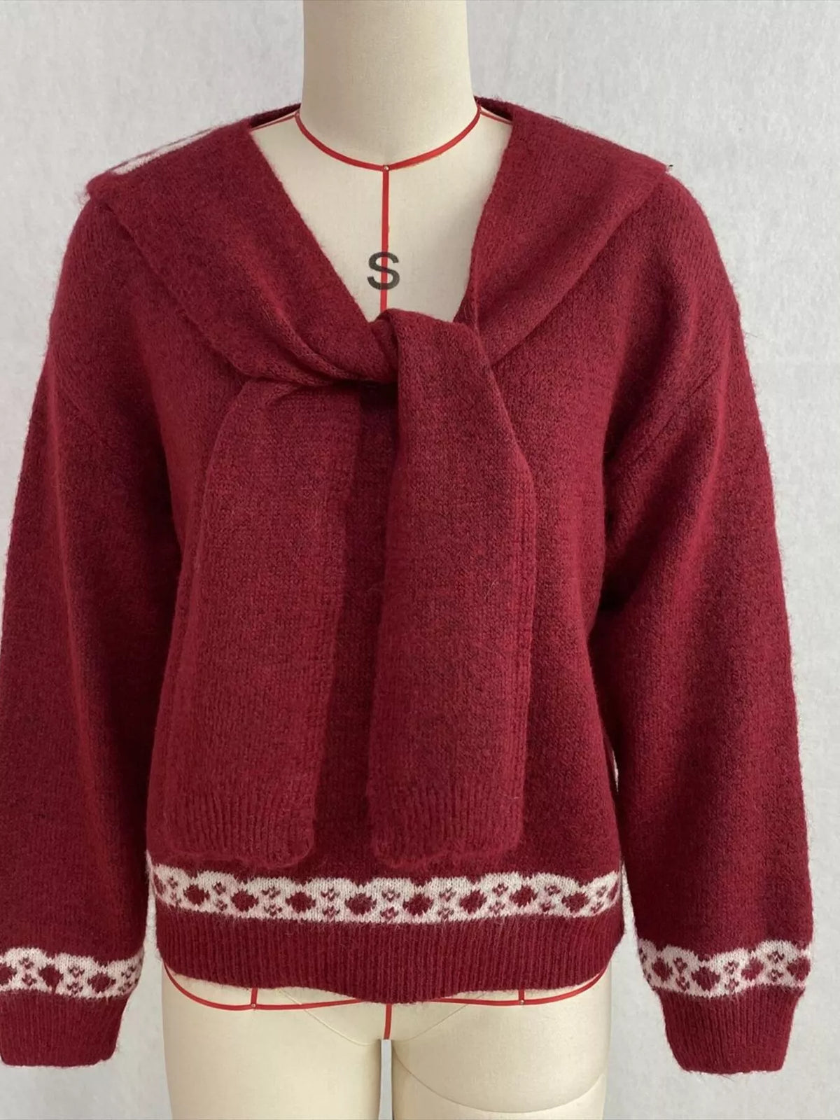 Red scarf-detail dropped-shoulder sweater, front on dress form.