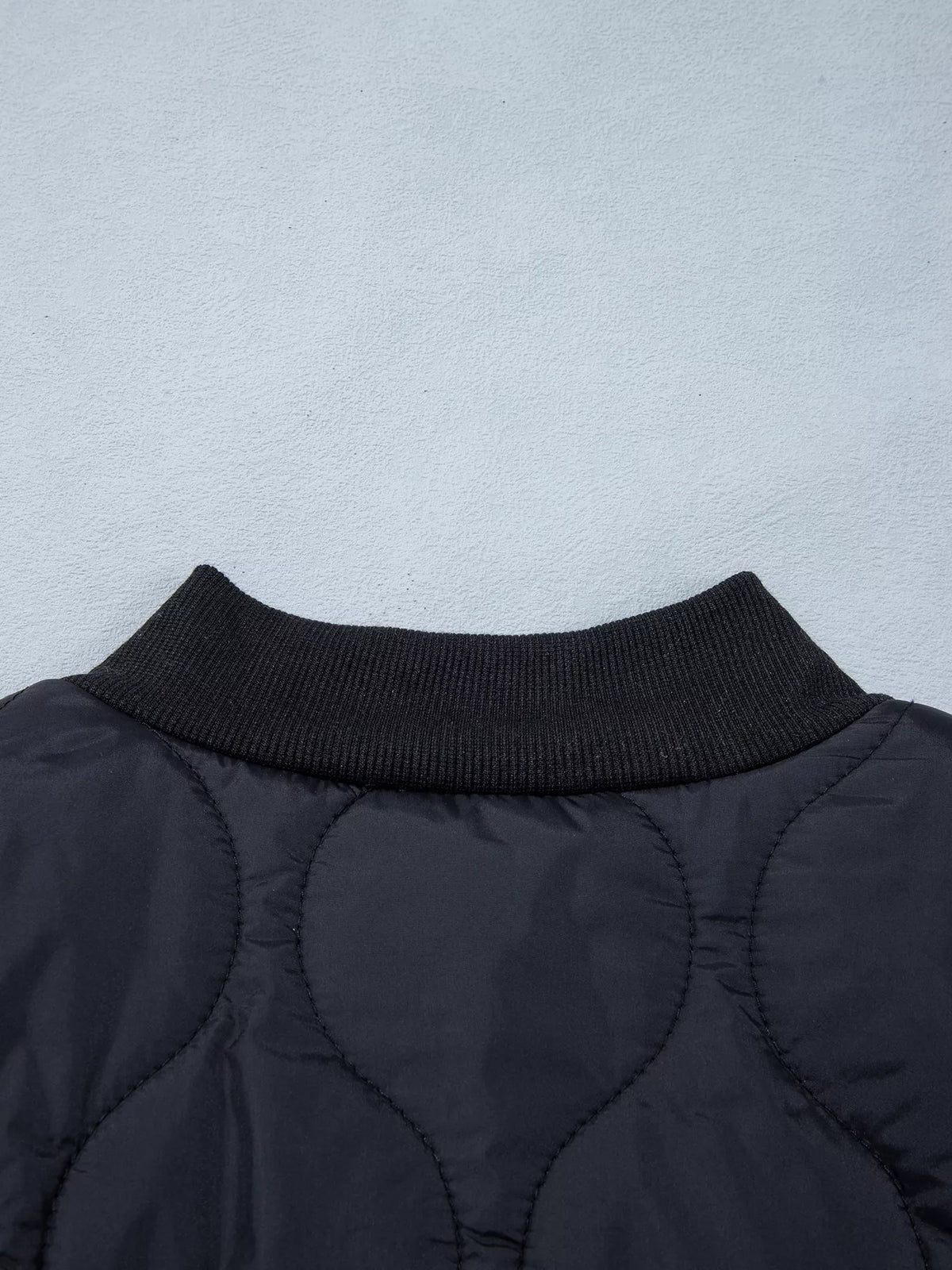 Quilted Leopard Cuff Button Down Puffer Jacket in black, construction detail