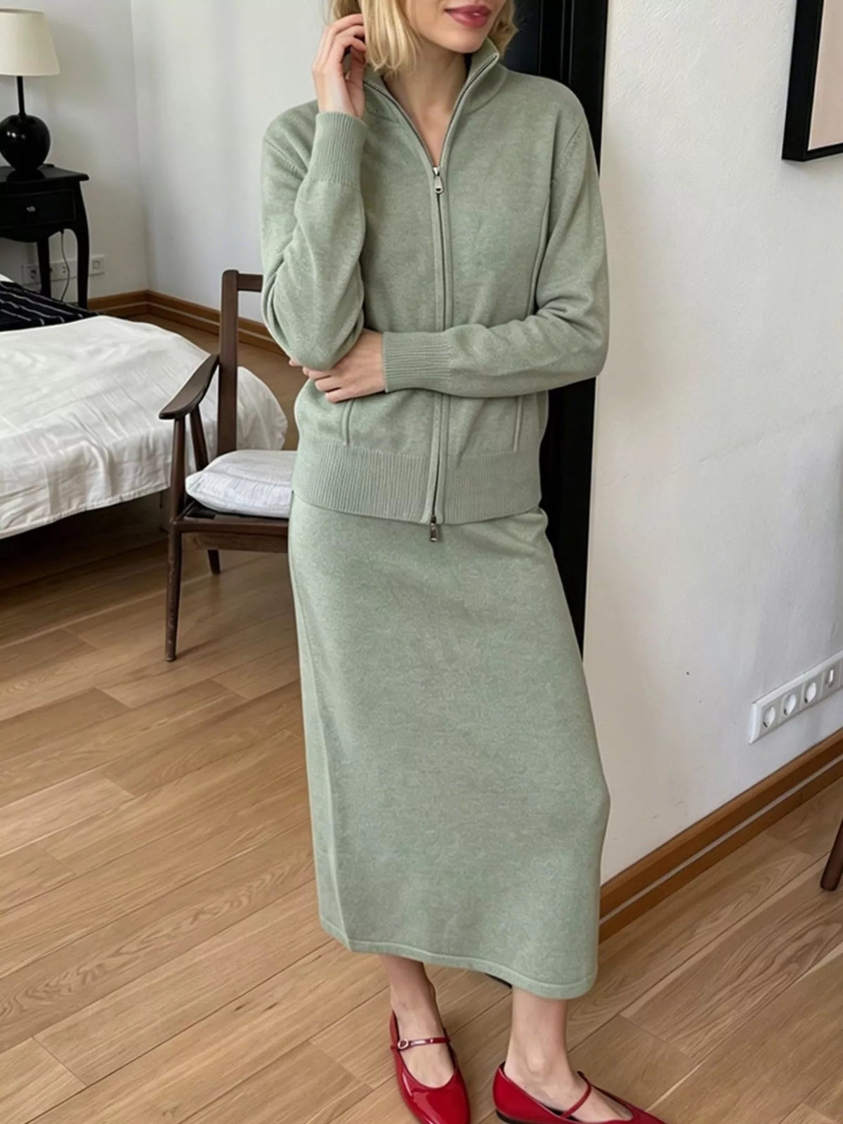 Zip-up cardigan and midi skirt knit set in sage green, crossed-arm view