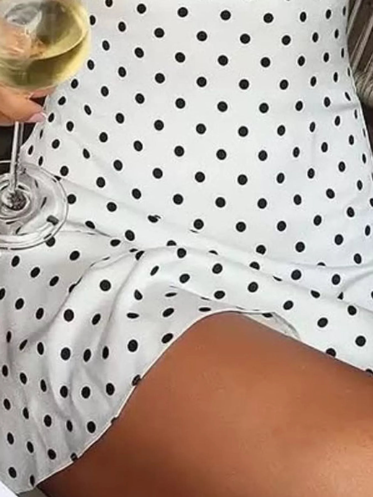 White and black polka dot halter neck mini dress, detail view