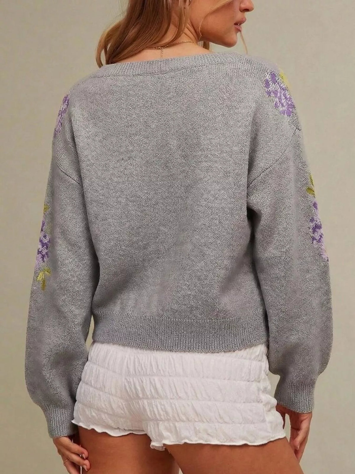 Gray floral pattern sweater, back view