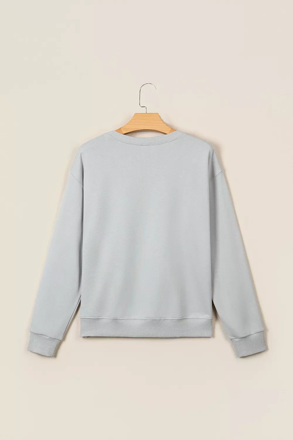 Gray floral and plaid PRAY patch sweatshirt, back on hanger