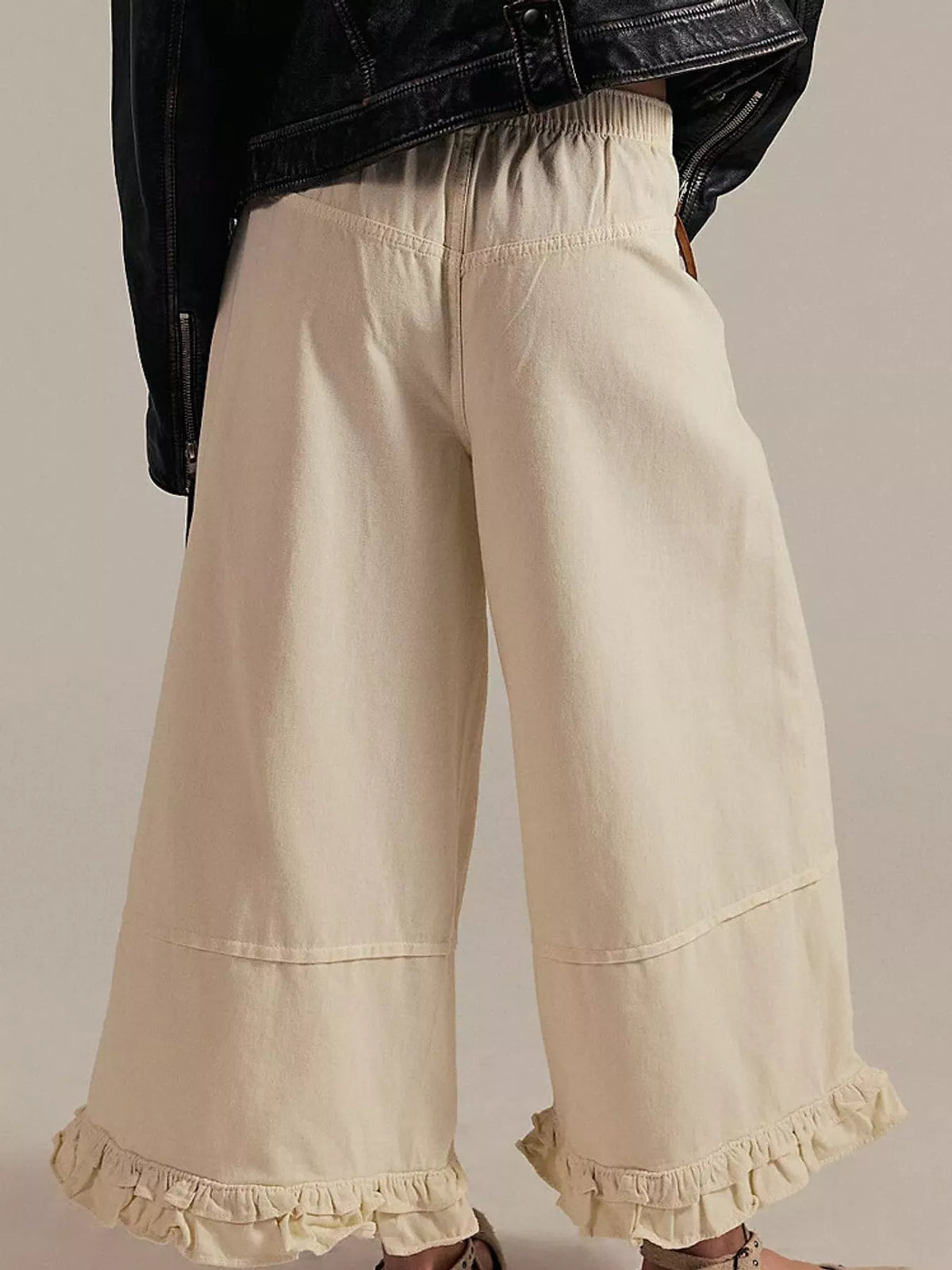Cream wide-leg ruffle-hem jeans, back view