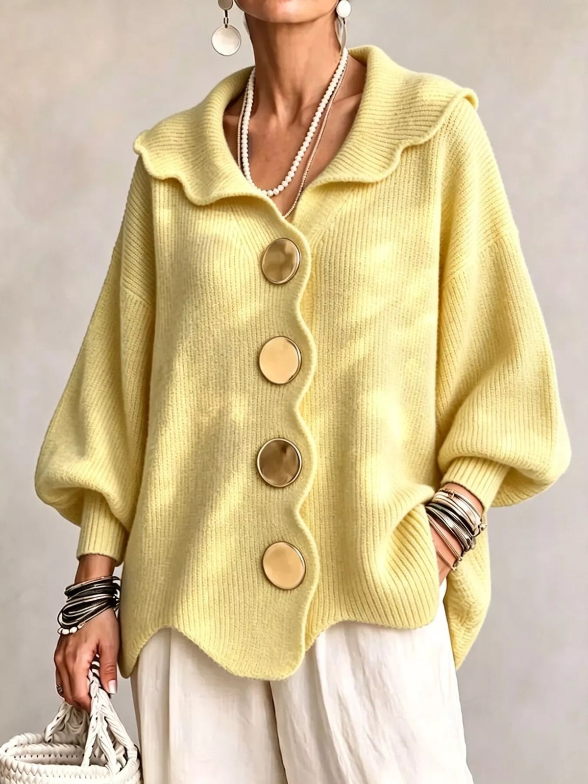 Pastel yellow scalloped-edge knit cardigan, front view