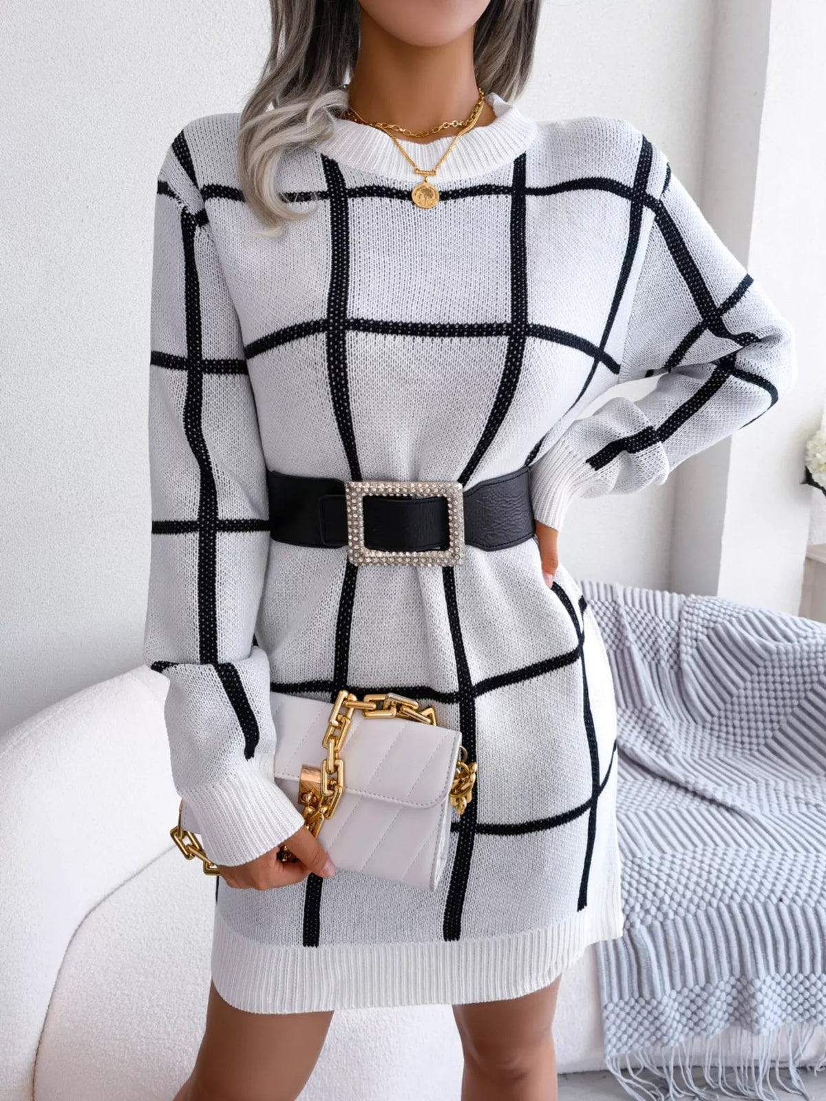 White windowpane long-sleeve sweater dress, belted front with handbag.