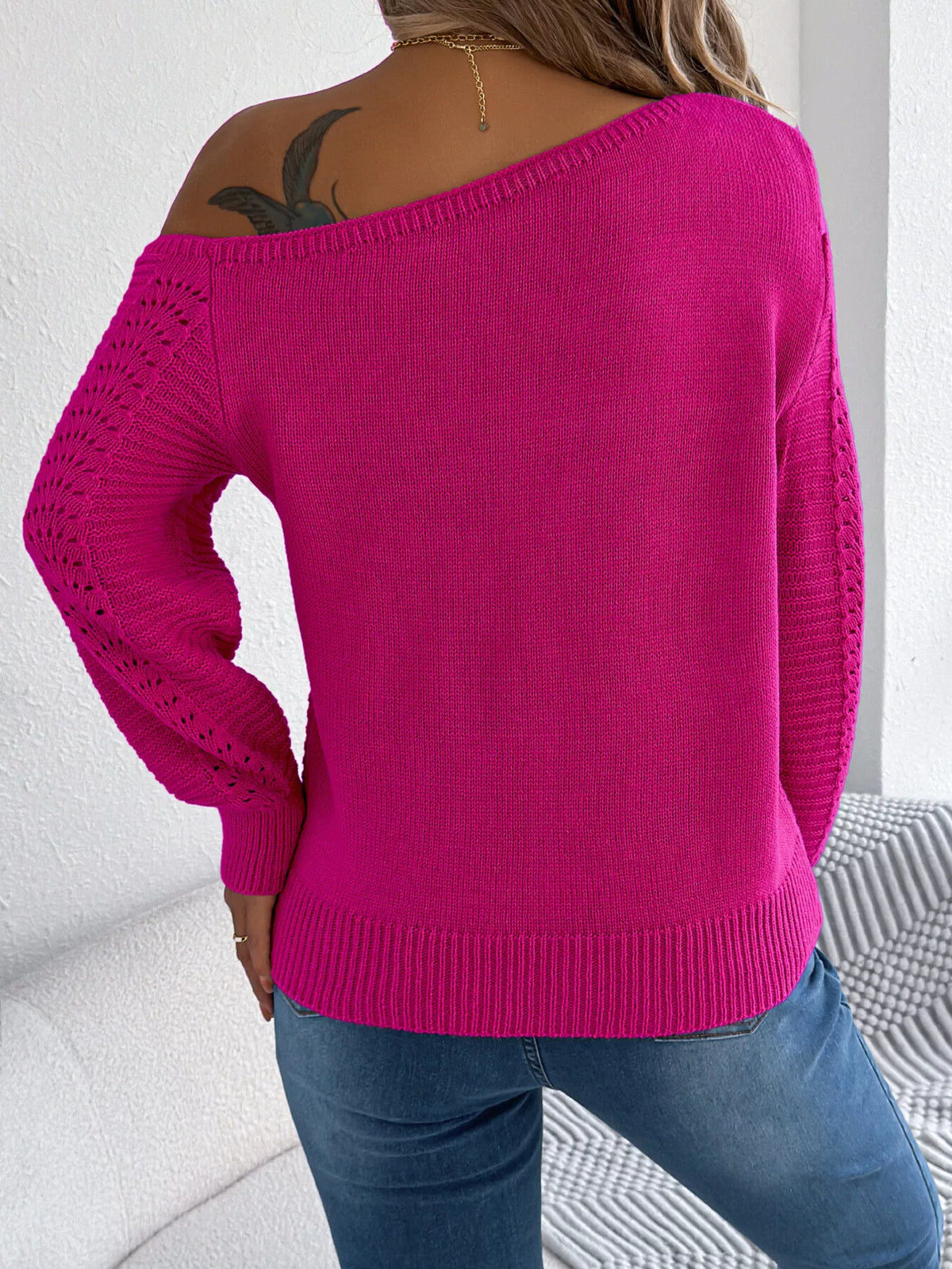 Cerise cold-shoulder openwork knit sweater, back view.