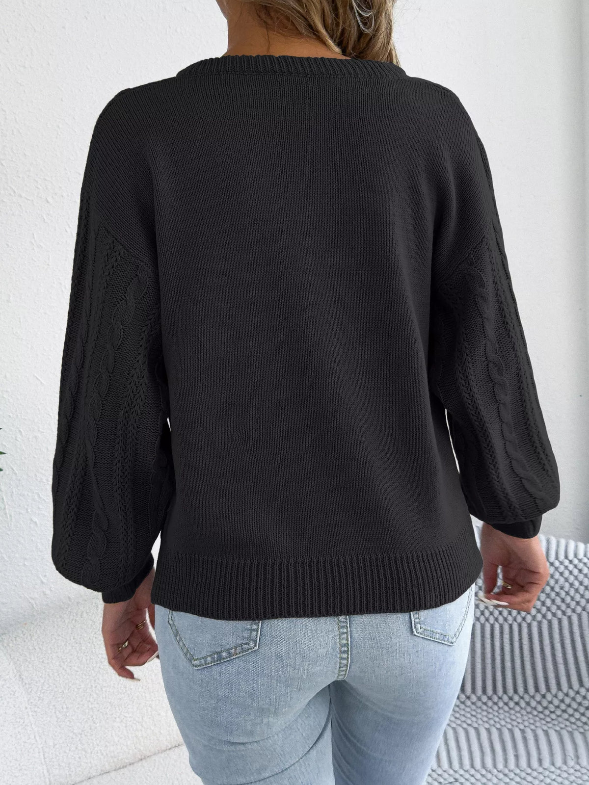 Black cable knit notched sweater, back view