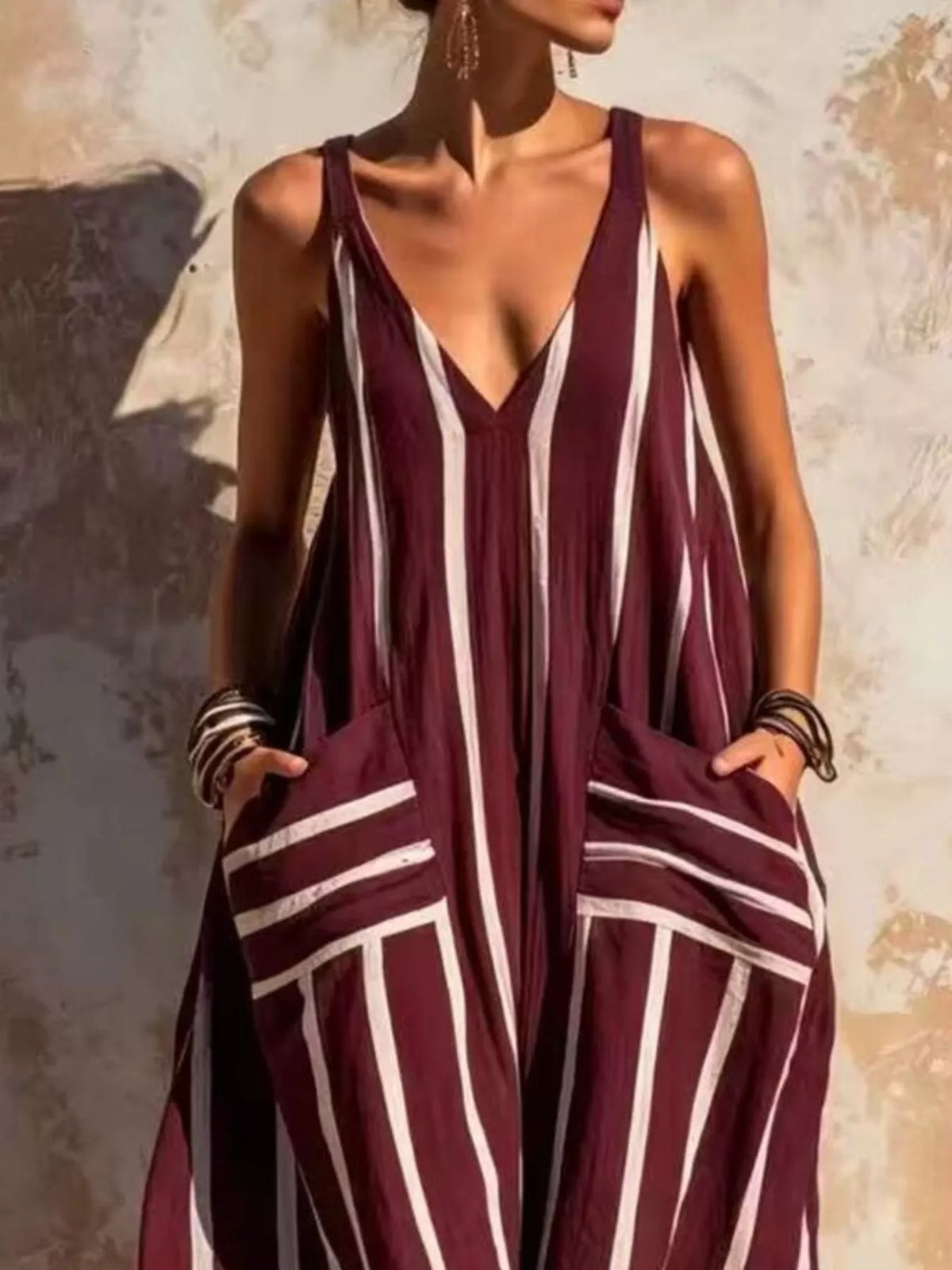 Burgundy and white striped sleeveless jumpsuit, neckline and pockets detail