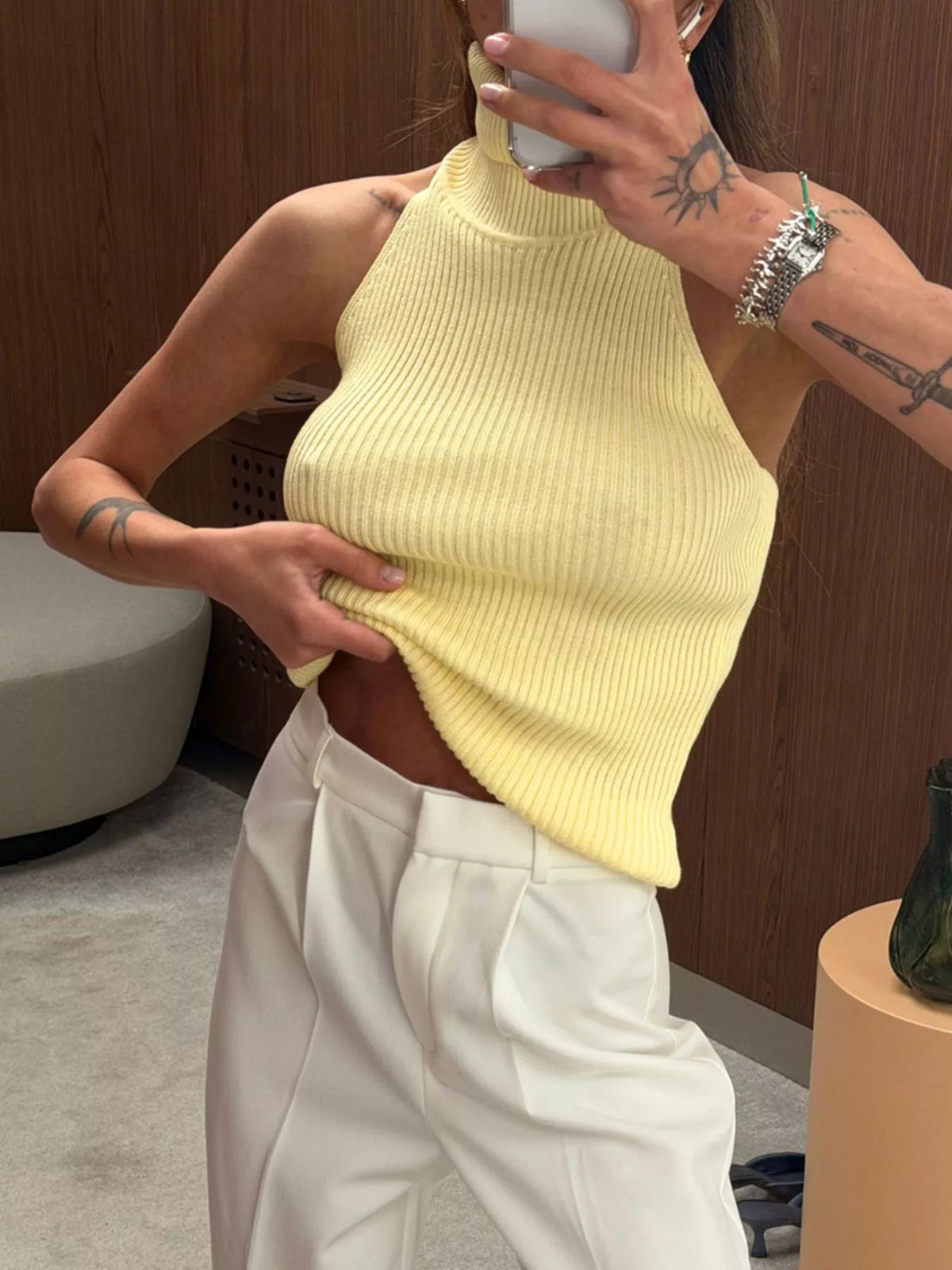 Yellow ribbed halter-neck tank, front view with hem lifted