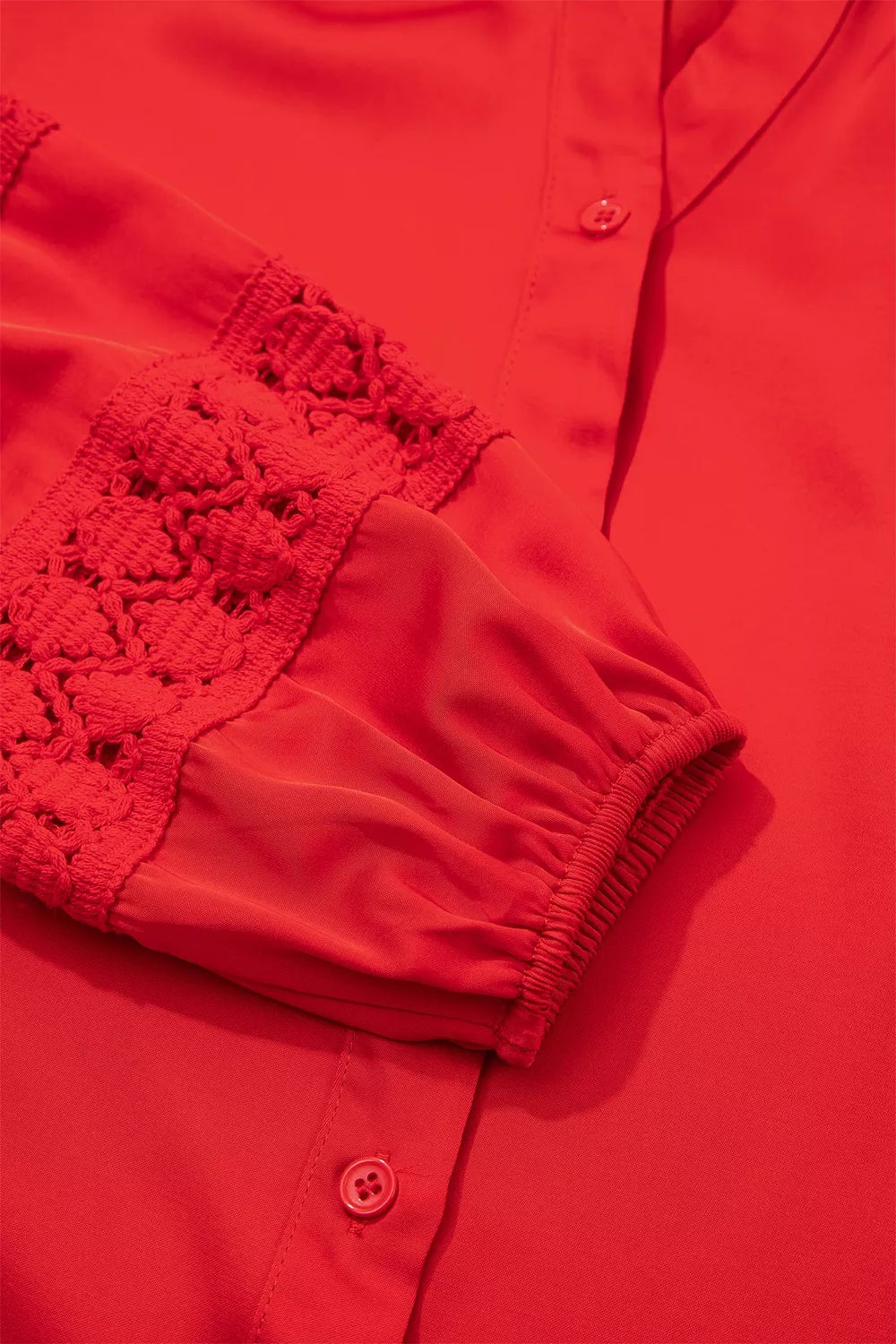 Red lace-panel v-neck button-front shirt, lace panel and cuff detail.