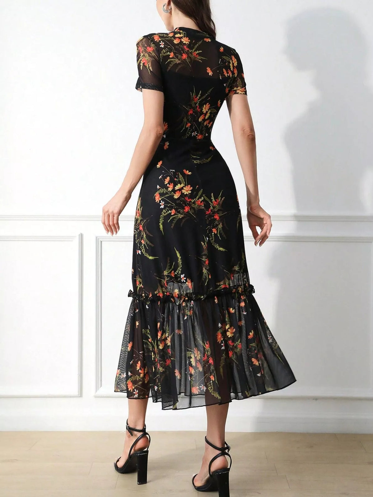 Black floral sheer-overlay midi dress with ruffle hem, back view