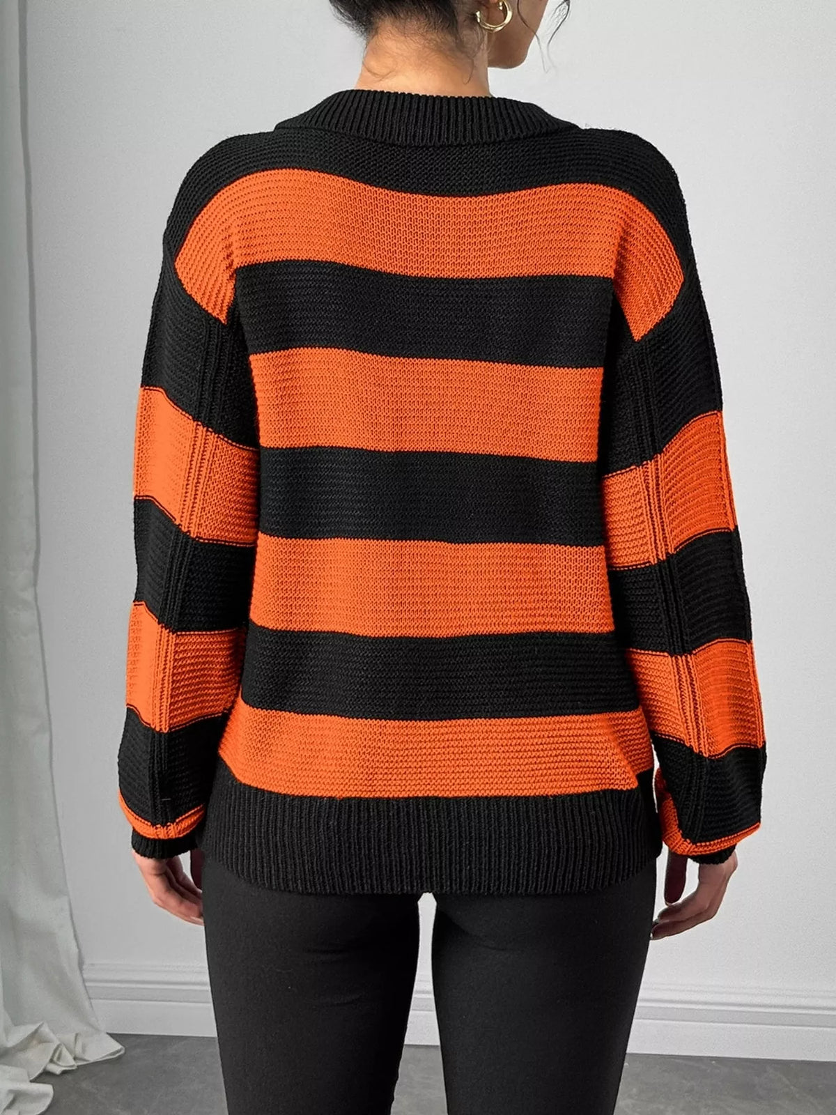 Orange striped polo collar sweater with floral pocket detail
