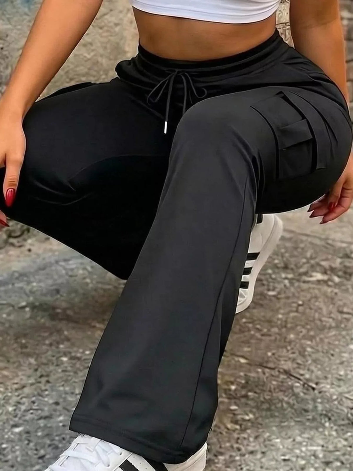 Black high-waisted slim-fit cargo flare pants with drawstring